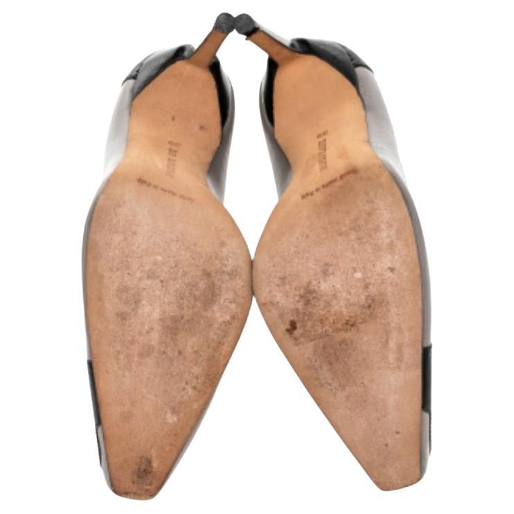 These contemporary Adra pumps by Manolo Blahnik will finish off any outfit with ultra-chic style. Crafted in leather and patent leather, these two-tone pumps are leather lined and feature cropped pointed toes. Blahnik's style is celebrated around