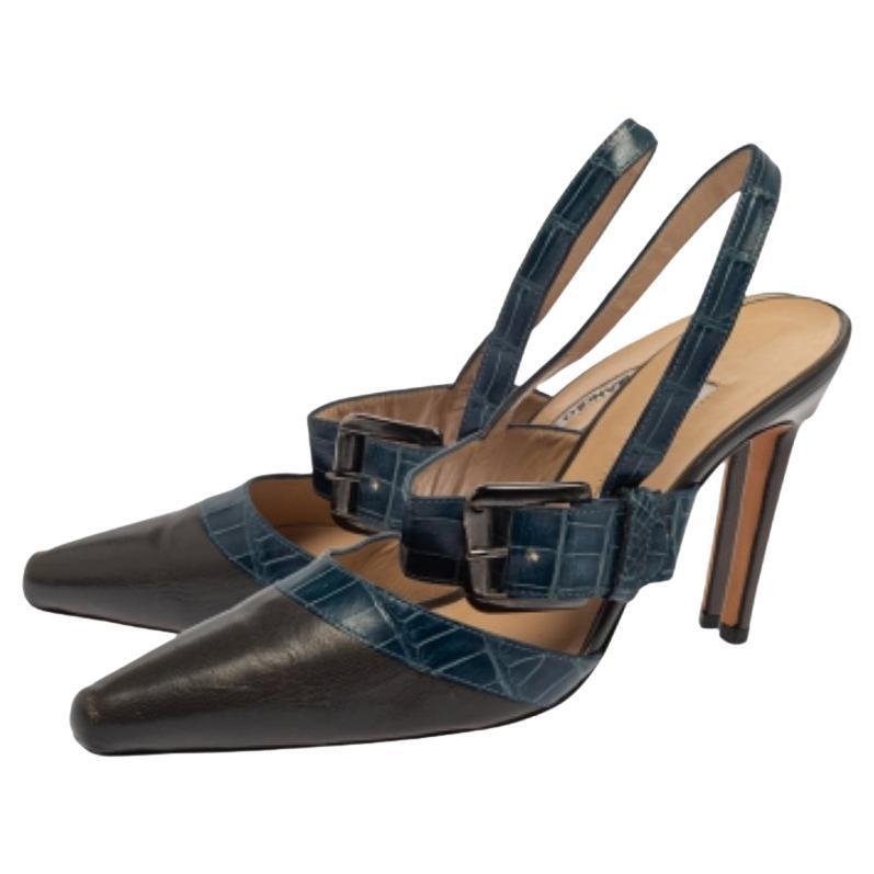 A beautiful pair of Manolo Blahnik shoes that's easy to wear and flaunt, these sandals are highly versatile. Constructed in leather, these shoes feature pointed toes, croc embossing, buckle strap, slingback closure, and 9.5 cm heels for an elegant