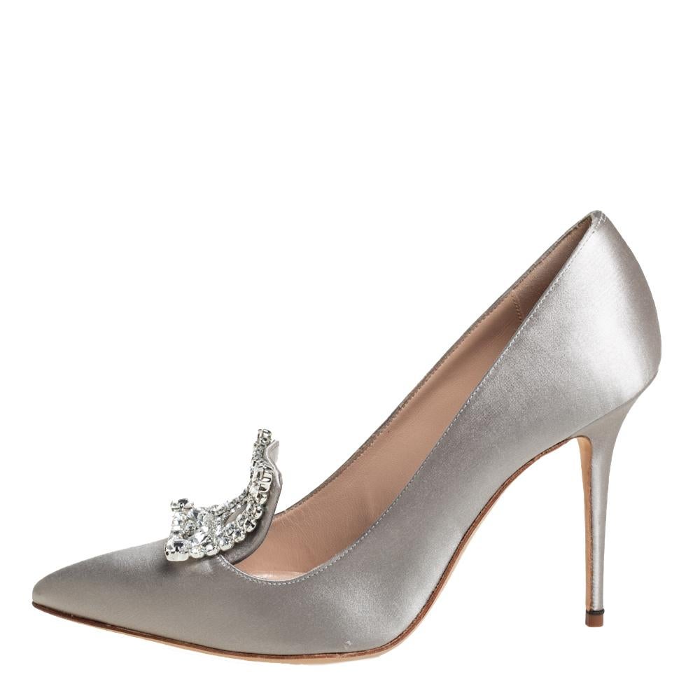 Walk with grace and confidence in these pumps by Manolo Blahnik. Styled as a pointed toe, with gorgeous crystal embellishment on the vamps, leather lining, and 10 cm high stiletto heels, this stylish grey satin pair will never fail to lift your