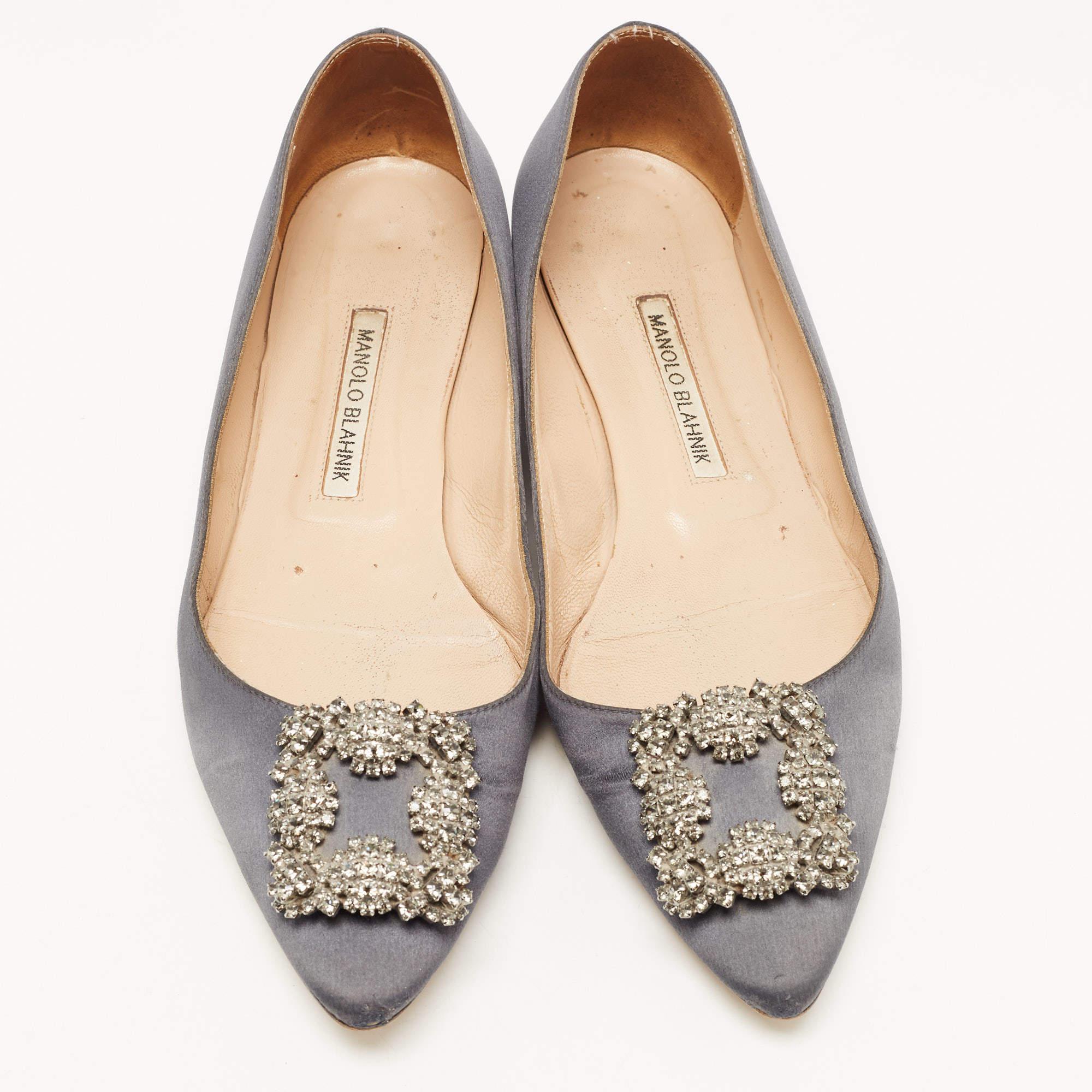 You know you are going to have a glamorous day the moment you put these ballet flats on. They are a Manolo Blahnik creation, meticulously crafted from satin and lined with leather on the insoles. The pair carries a classic grey hue and