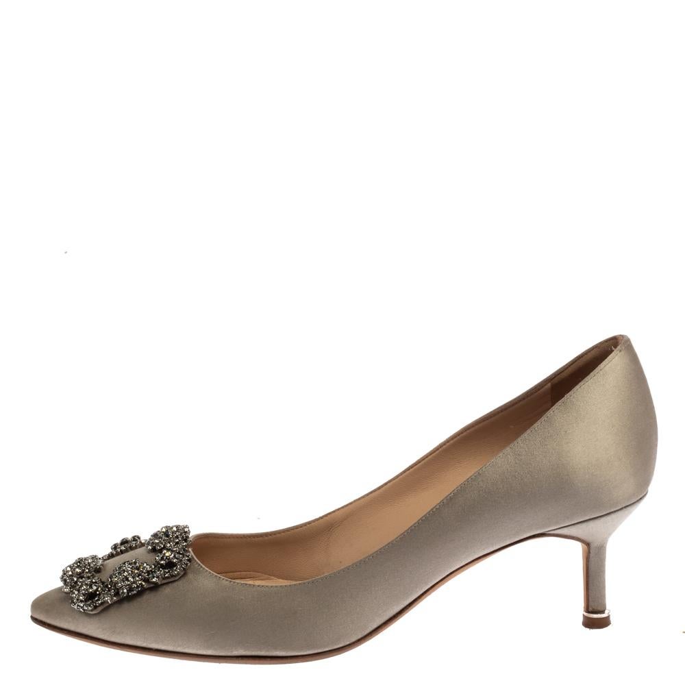 Manolo Blahnik is well-known for his graceful designs, and his label is synonymous with opulence, femininity, and elegance. These iconic Hangisi pumps are crafted from satin in a grey shade into a pointed toe silhouette augmented by the dazzling