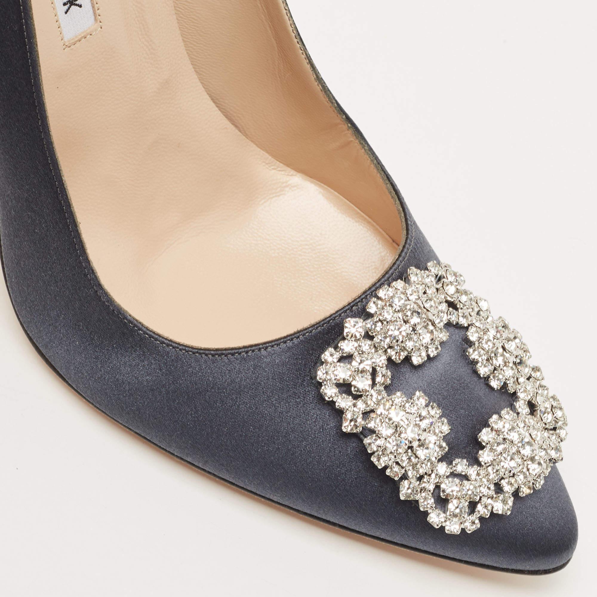 The 11cm heels of this pair of Manolo Blahnik pumps will reflect grace and luxury in every step. Made from satin, it is made striking with a crystal-embellished buckle detailing on the toes and exhibits branded insoles.

Includes: Original Dustbag