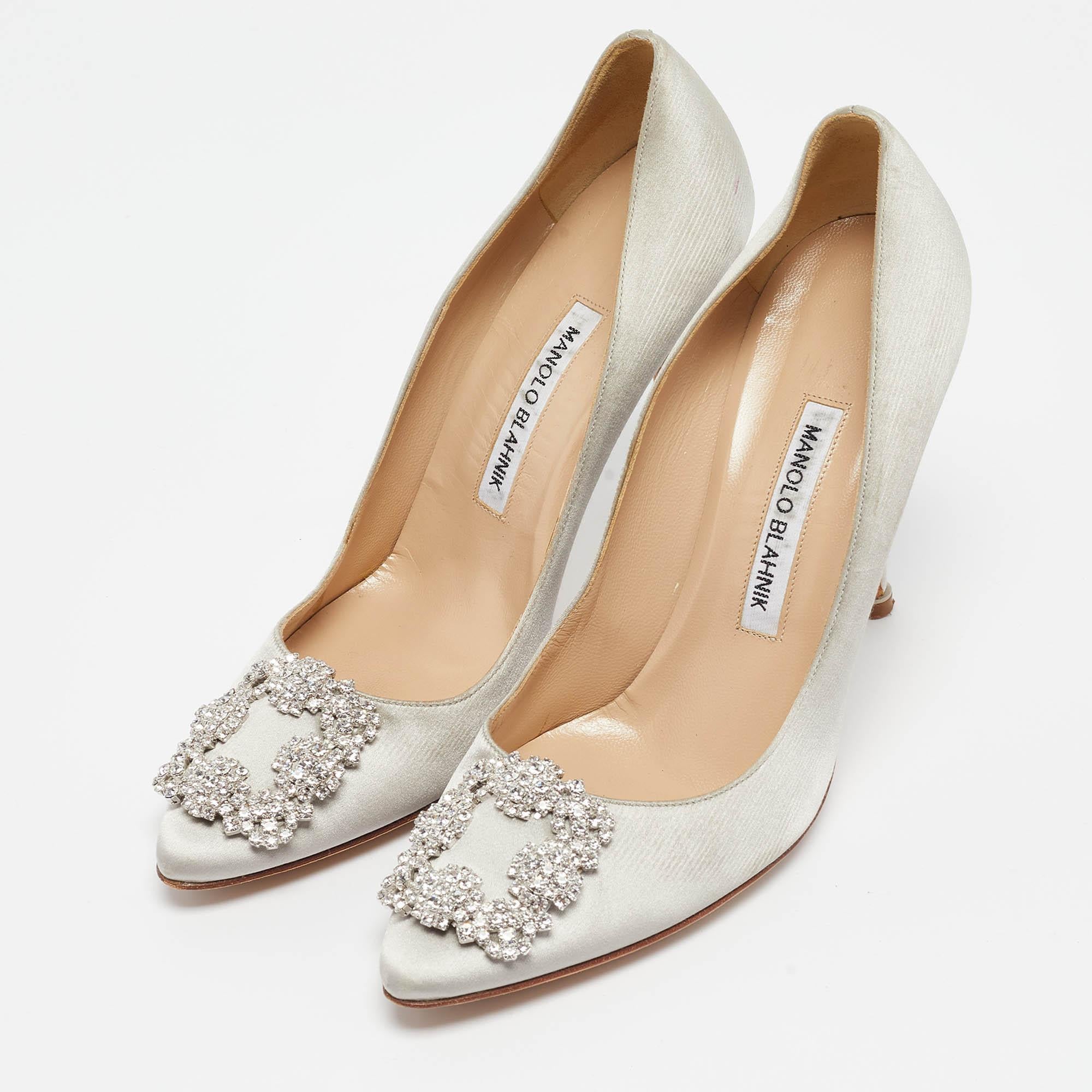 The 11cm heels of this pair of Manolo Blahnik pumps will reflect grace and luxury in every step. Made from satin, it is made striking with crystal-embellished buckle detailing on the toes and exhibits branded insoles. 