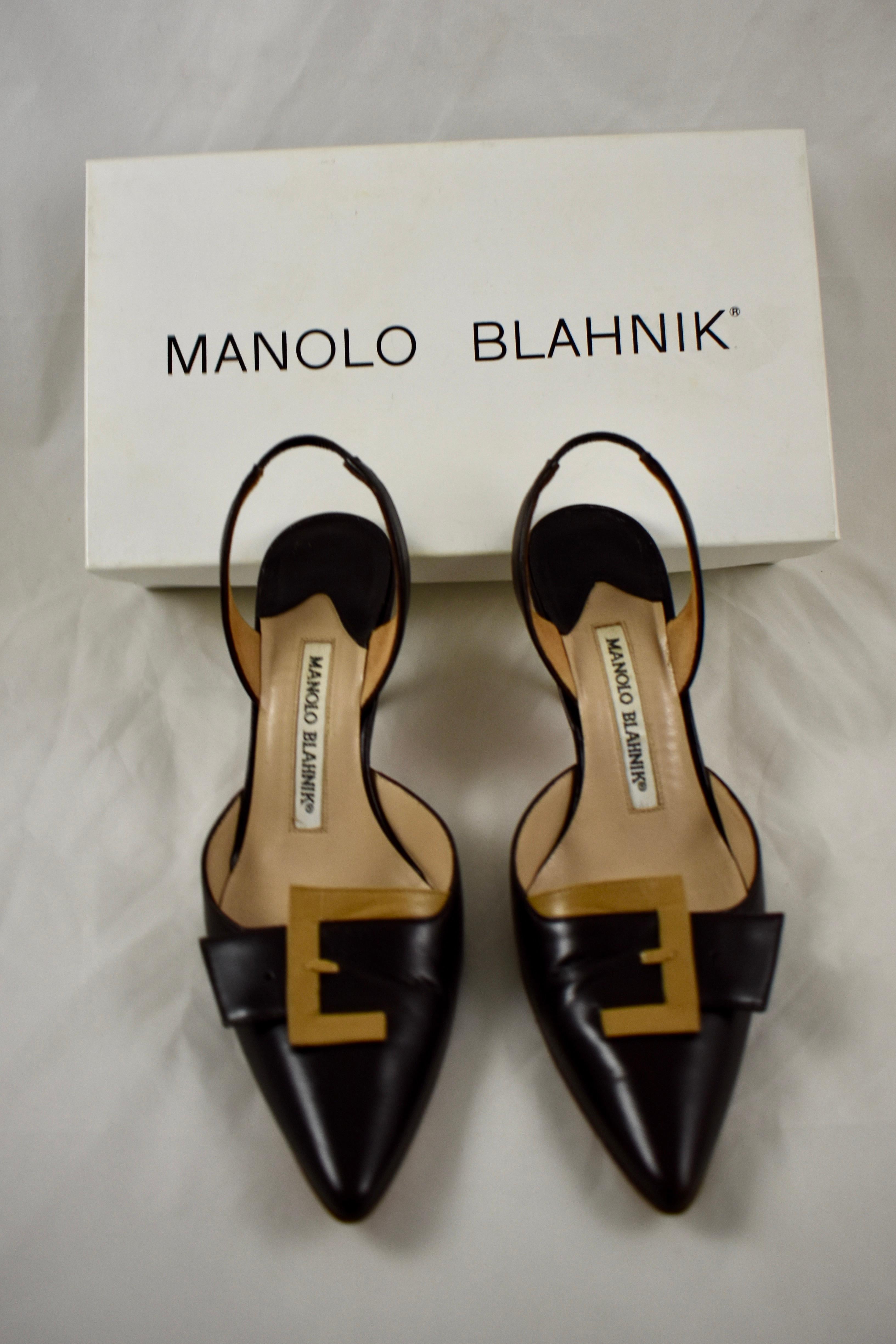 A pair of slingback pumps by Manolo Blahnik, with the original box showing a Saks fifth avenue label.

Style: Lolasling Kid Brown - Kid 68. Tor 70
Size: 35 1/2 with a 3
