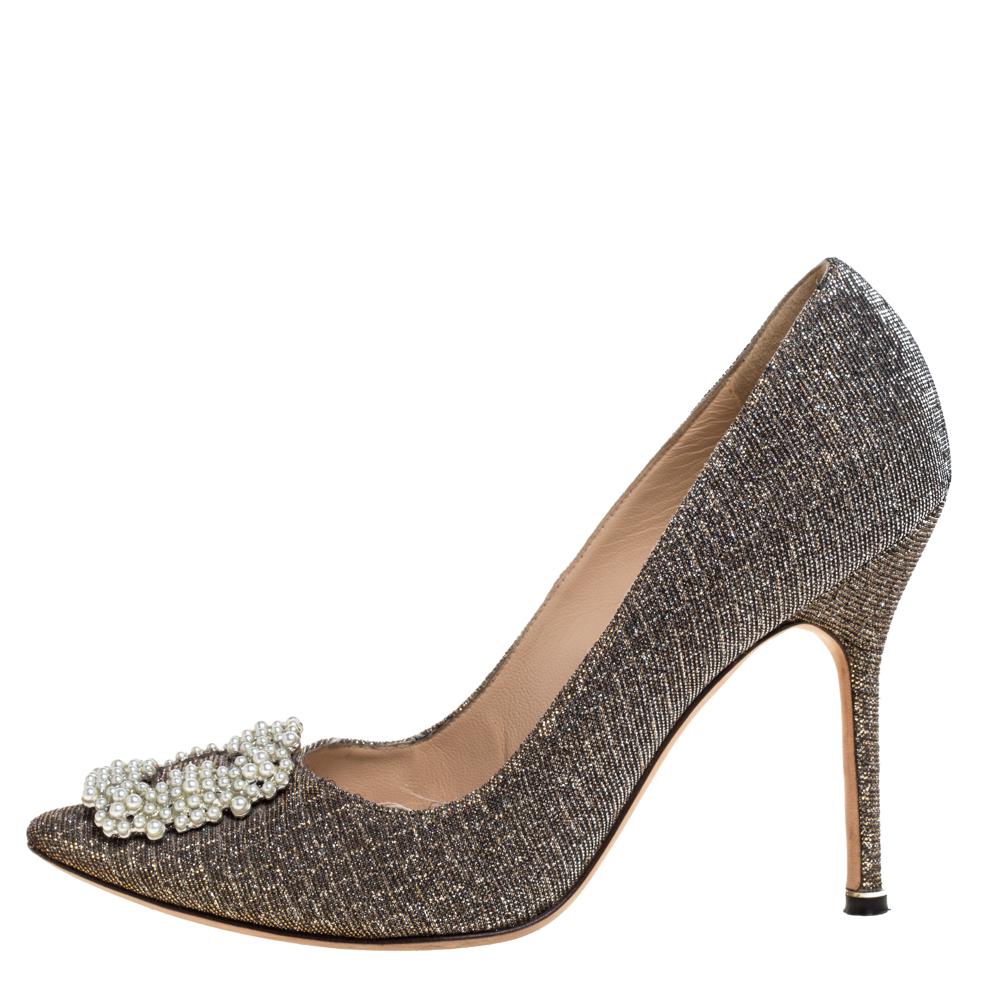 These iconic pumps are by Manolo Blahnik. Styled in metallic glitter fabric, with dazzling embellishments on the toes, and leather insoles to provide comfort, these luxurious pumps will never fail to lift your outfits. Complete with 11 cm heels, you