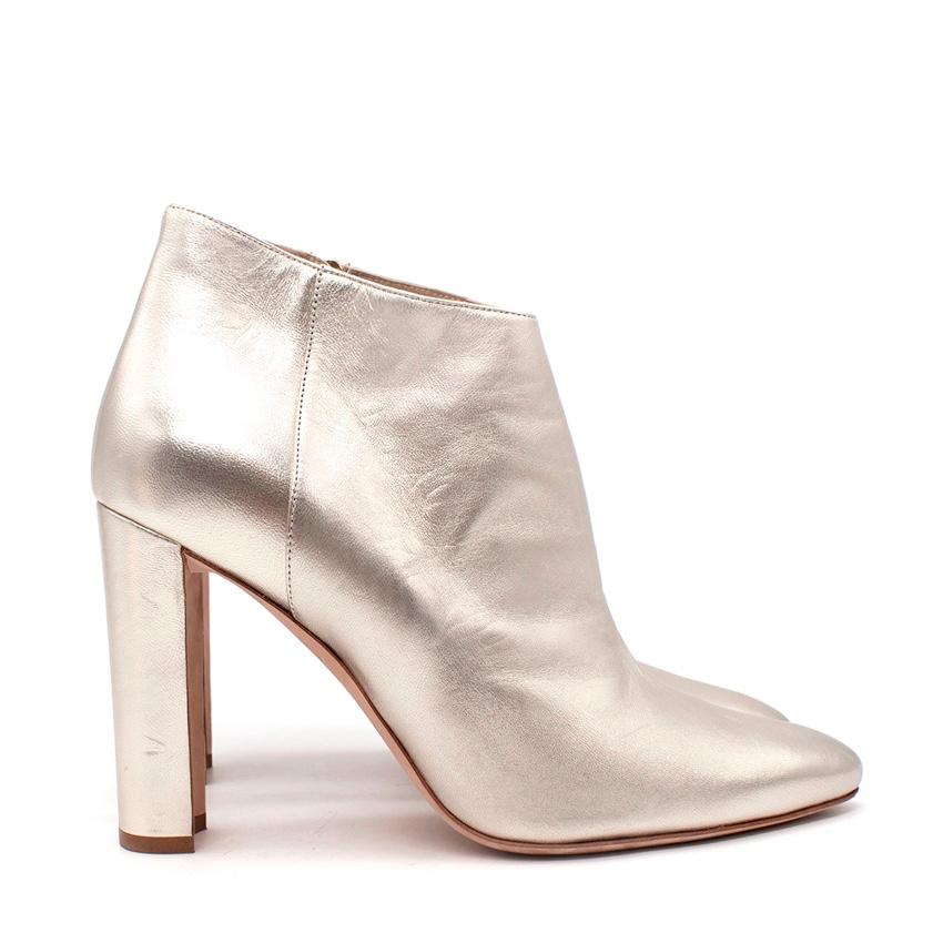Manolo Blahnik Metallic Gold Heeled Ankle Boots
 

 - Classic heeled bootie shape, modernised in a soft pale gold metallic nappa leather
 - Almond toe, close-fitting shape, finishing at the ankle bone, set on a high leather-covered block heel
 -