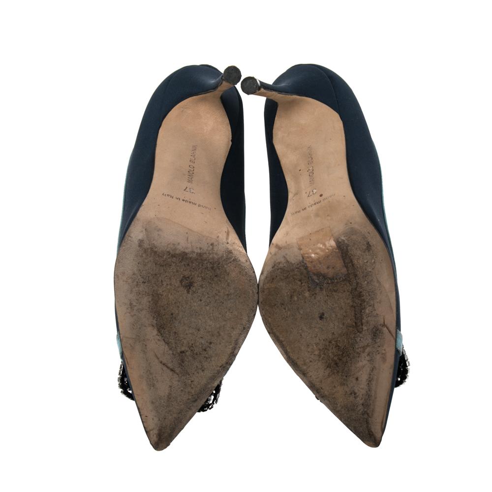 Manolo Blahnik is well-known for his graceful designs, and his label is synonymous with opulence, femininity, and elegance. These Hangisi pumps are crafted from navy blue fabric & canvas into a pointed toe silhouette augmented by the embellishments