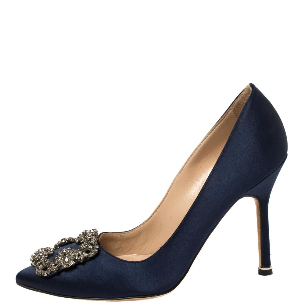 These iconic pumps are by Manolo Blahnik. Styled in navy blue satin with dazzling crystal-embellished accents on the toes, and leather insoles to provide comfort, these luxurious pumps will never fail to lift your outfits. Complete with 9.5 cm
