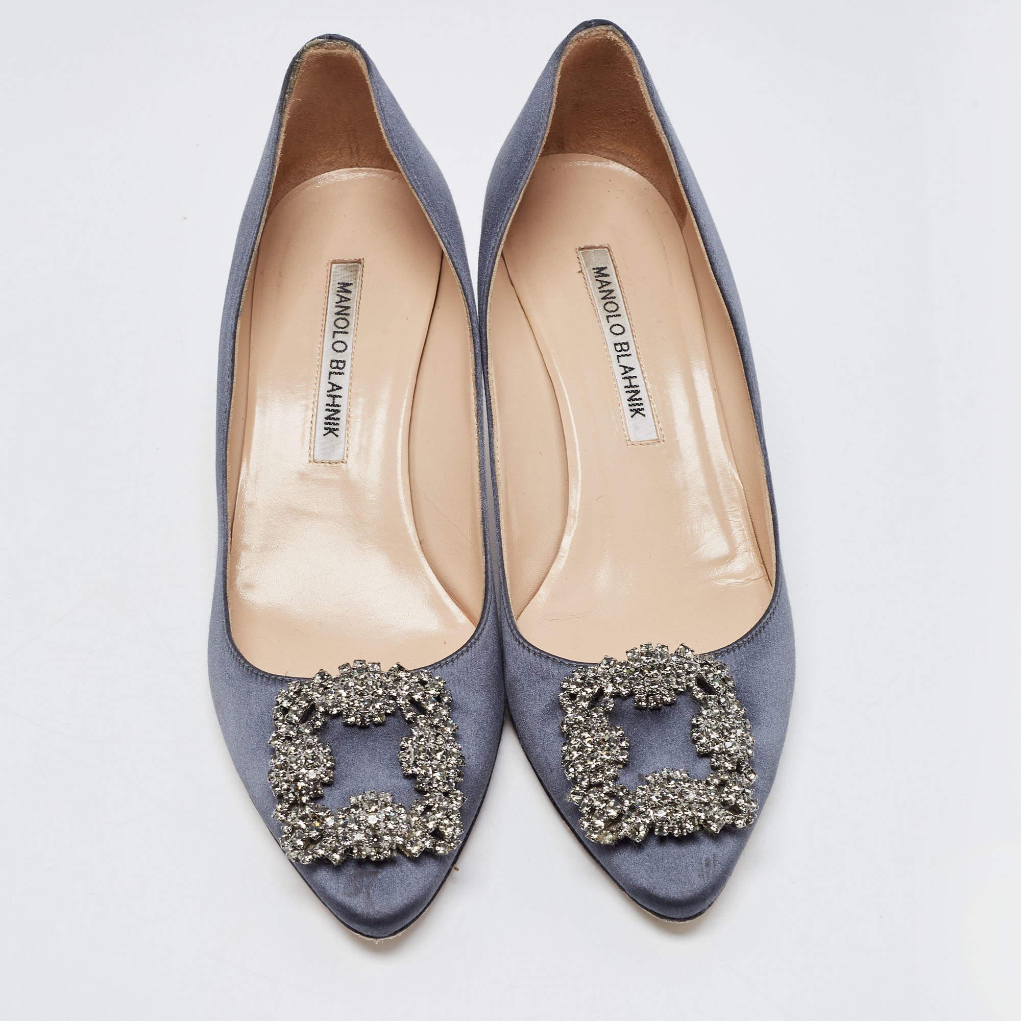 The 5cm heels of this pair of Manolo Blahnik pumps will reflect grace and luxury in every step. Made from satin with beautiful navy blue shade on exterior , it is made striking with crystal-embellished buckle detailing on the toes and exhibits