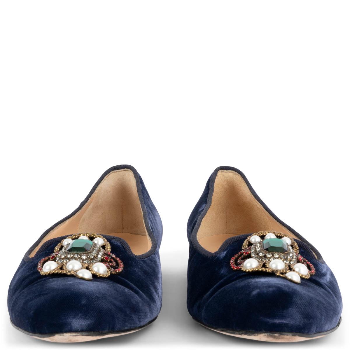 100% authentic Manolo Blahnik Eufrasia Limited Edition loafers in navy blue velvet embellished with faux pearls and rhinestones with one chunky green gem in the middle. Have been worn once or twice and are in excellent condition.