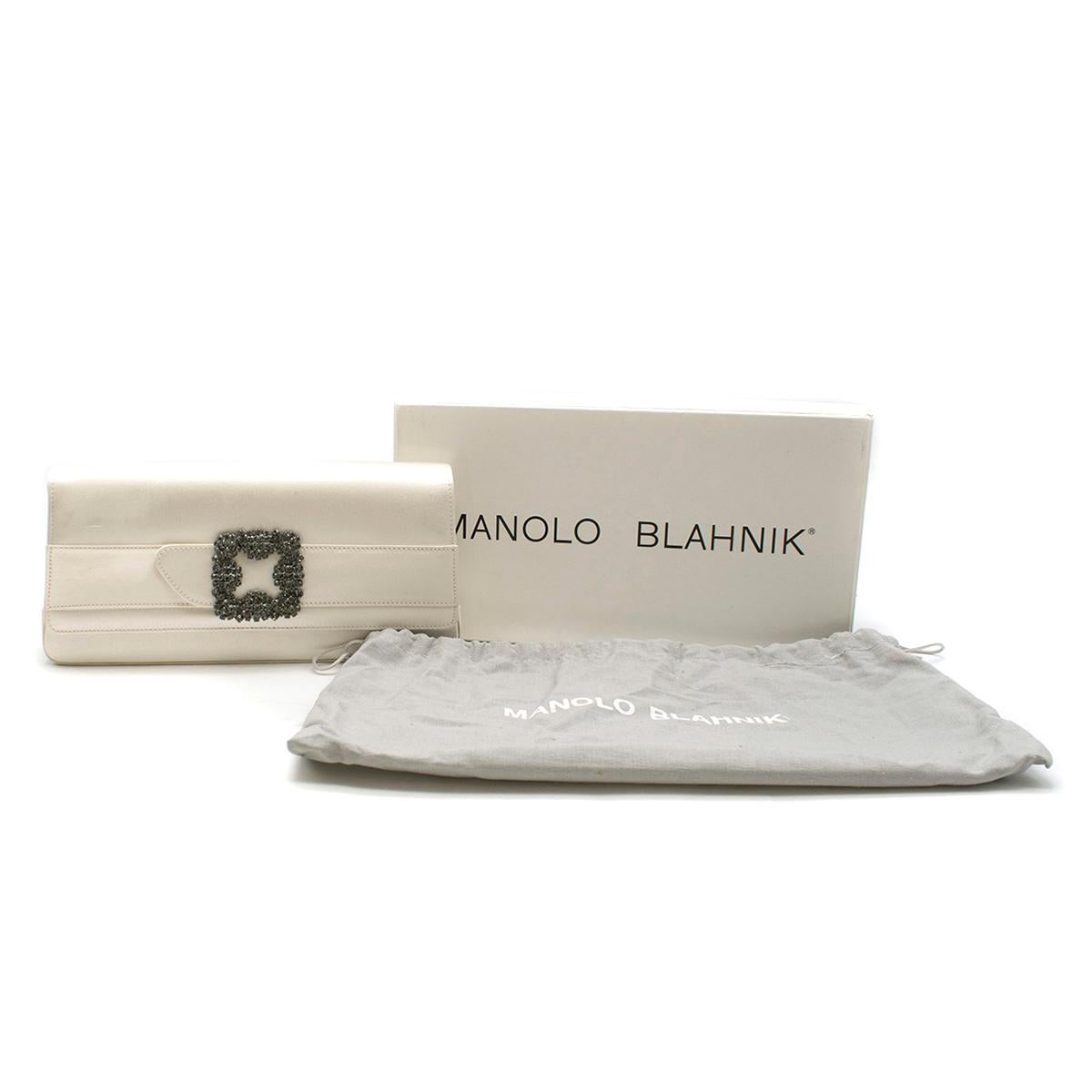 Manolo Blahnik Off-white Satin Jewel Buckle Clutch

- Off-white clutch bag 
- Rectangular 
- Satin 
- Flap-over design with Swarovski crystal buckle 
- Internal compartment, mirror and removable chains with two length options. 
- Magnetic closure 
-