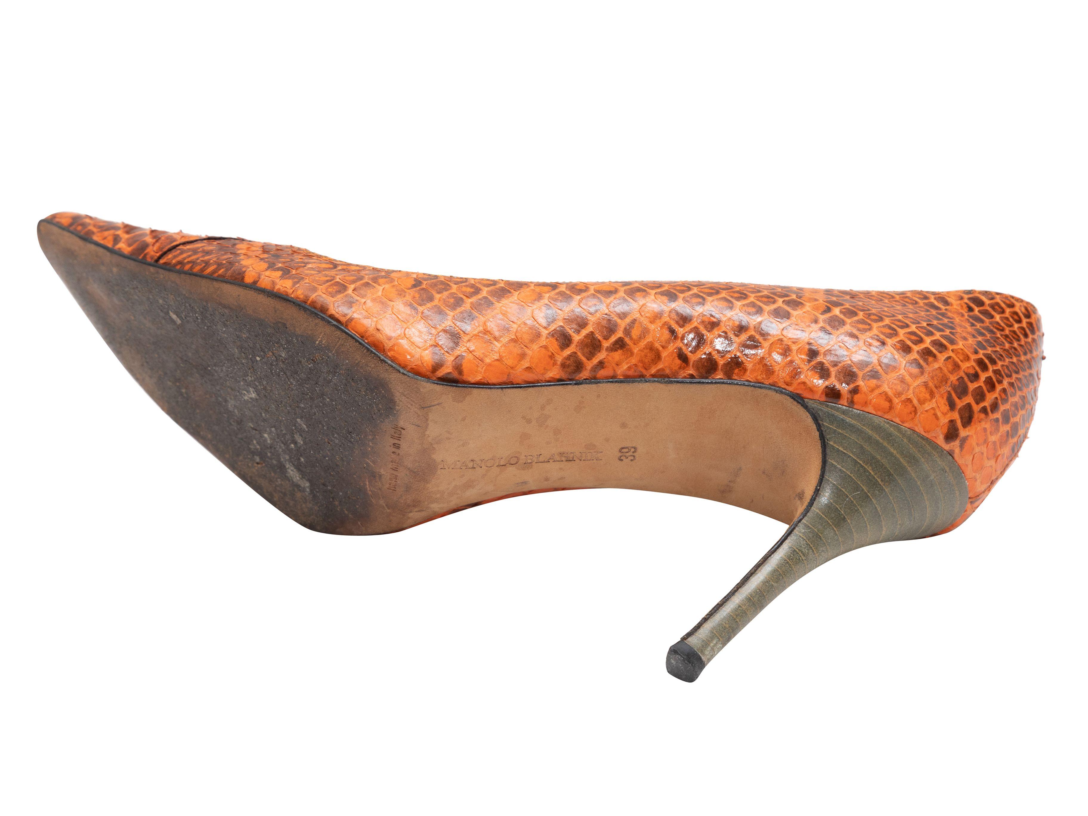 Product Details: Orange and brown snakeskin pointed-toe pumps by Manolo Blahnik. Stacked heels. 3.5