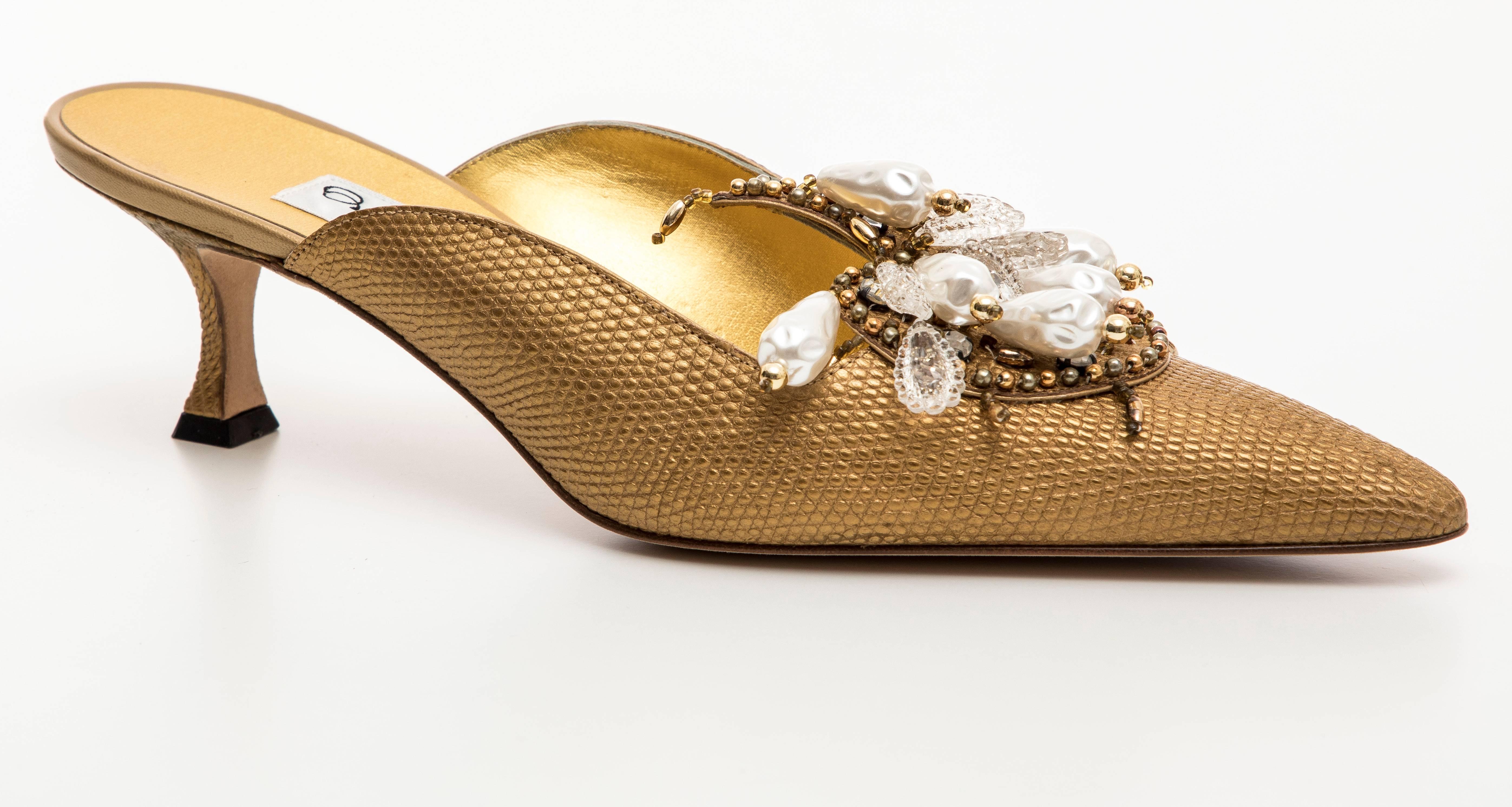 Manolo Blahnik, Circa 1998 Orientalia pale gold metallic lizard skin mules with faux pearls, beads and crystals.

IT. 39, US. 9

Orientalia mules were originally designed for Paloma Picasso in the 1980's. They were later released in different colors