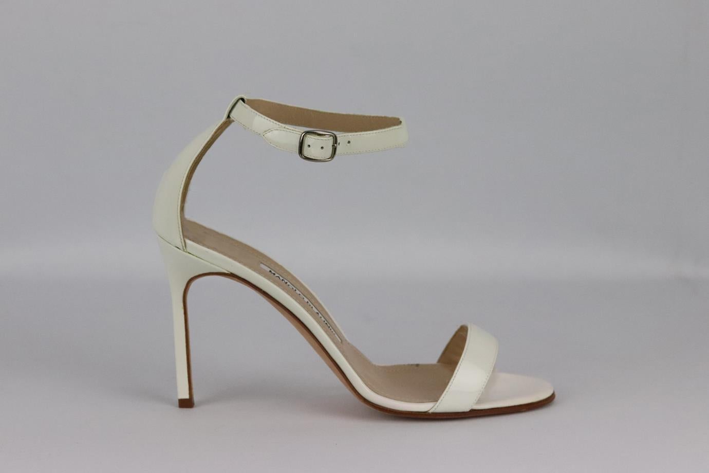 Manolo Blahnik patent leather sandals. White. Buckle fastening at side. Does not come with dustbag and box. Size: EU 37.5 (UK 4.5, US 7.5). Insole: 9.5 in. Heel: 3 in. Very good condition - Light wear to soles. Light marks to upper material; see
