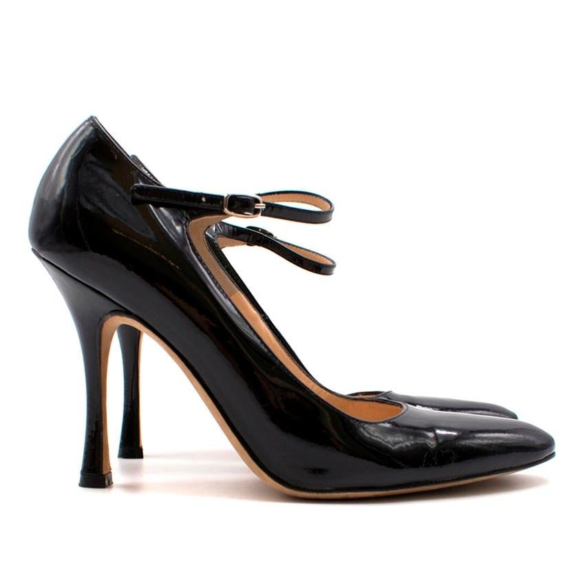 Manolo Blahnik Patent Mary-Jane Heeled Pumps

- Black patent leather
- Rounded point toe
- Leather strap with silver-tone buckle to fasten
- Beige leather lining and insole

Please note, these items are pre-owned and may show some signs of storage,