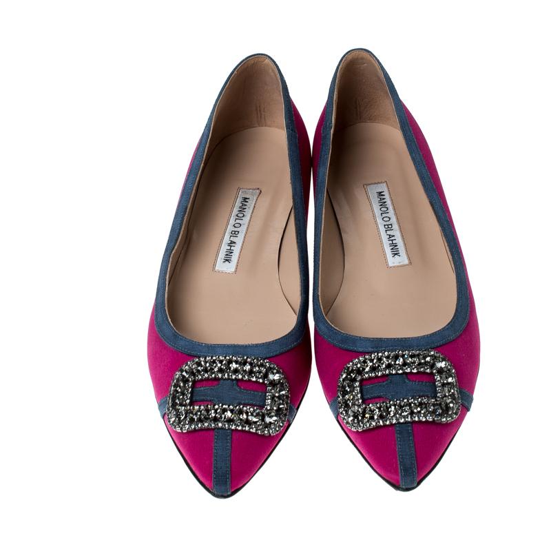 A classic pair of Manolo Blahniks is loved by women all over for its comfort and grace. These pretty shoes are constructed from pink satin fabric and it further made special with a buckle style crystal embellished design at the front which is unique