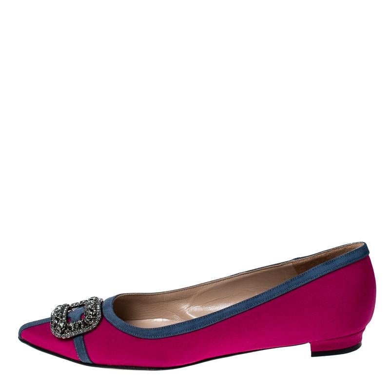 A classic pair of Manolo Blahniks is loved by women all over for its comfort and grace. These pretty shoes are constructed from pink satin fabric and it further made special with a buckle style crystal embellished design at the front which is unique