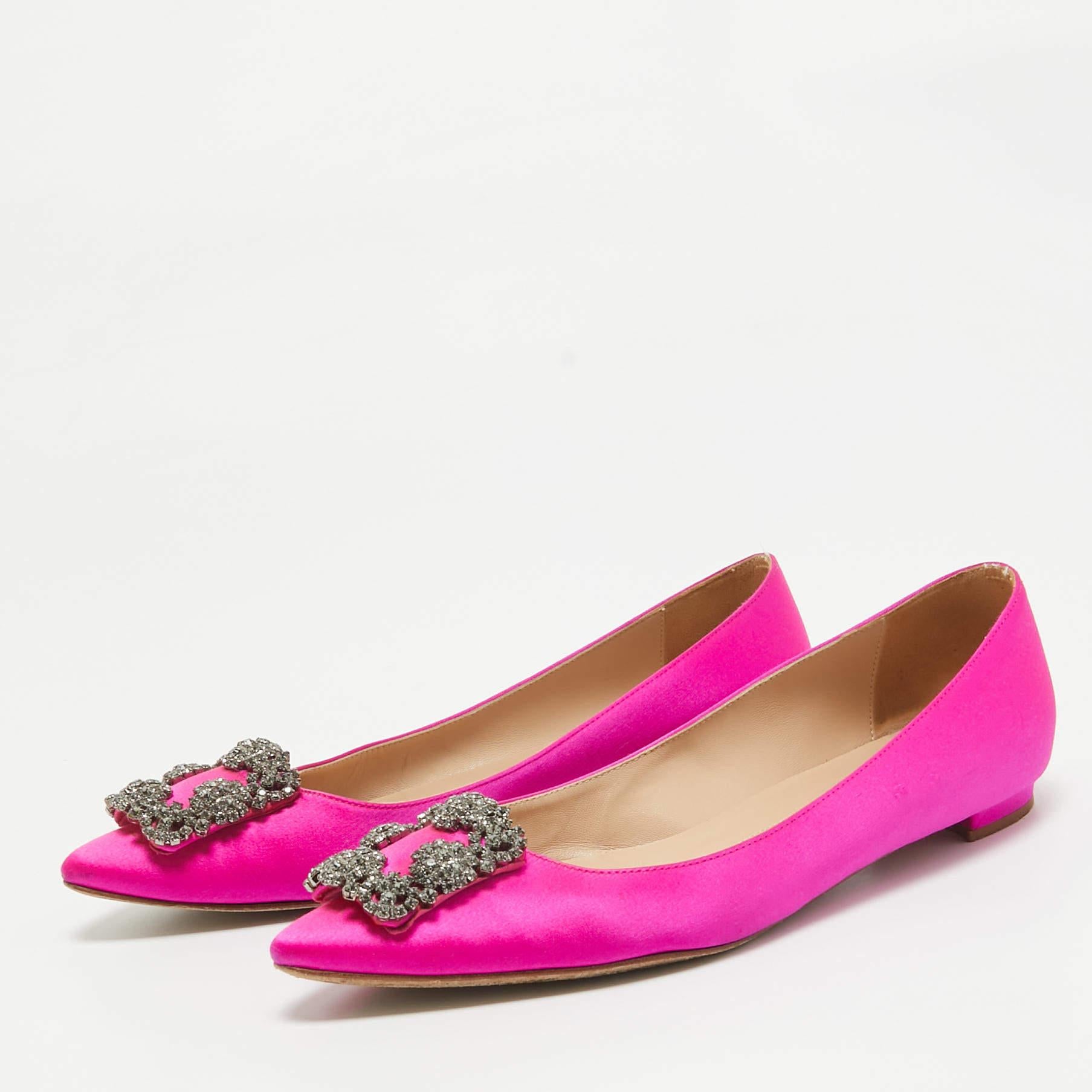 Topped with crystal embellishment on the toes these Manolo Blahnik ballet flats exemplify grace and beauty. They are made from satin with a slip on fitting for convenience and are set on durable soles.