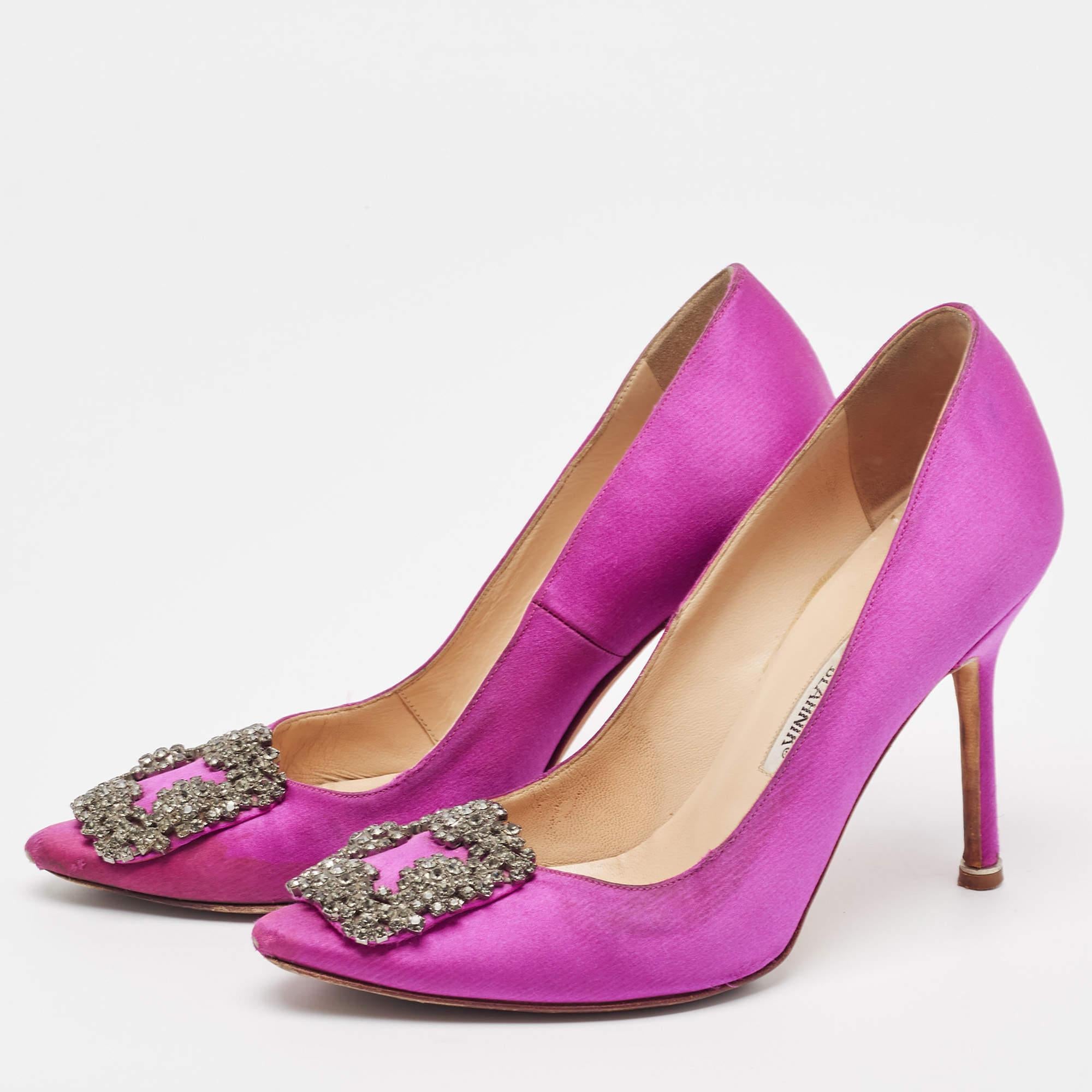 The 9.5cm heels of this pair of Manolo Blahnik pumps will reflect grace and luxury in every step. Made from satin it is made striking with crystal embellished buckle detailing on the toes and exhibits branded insoles.