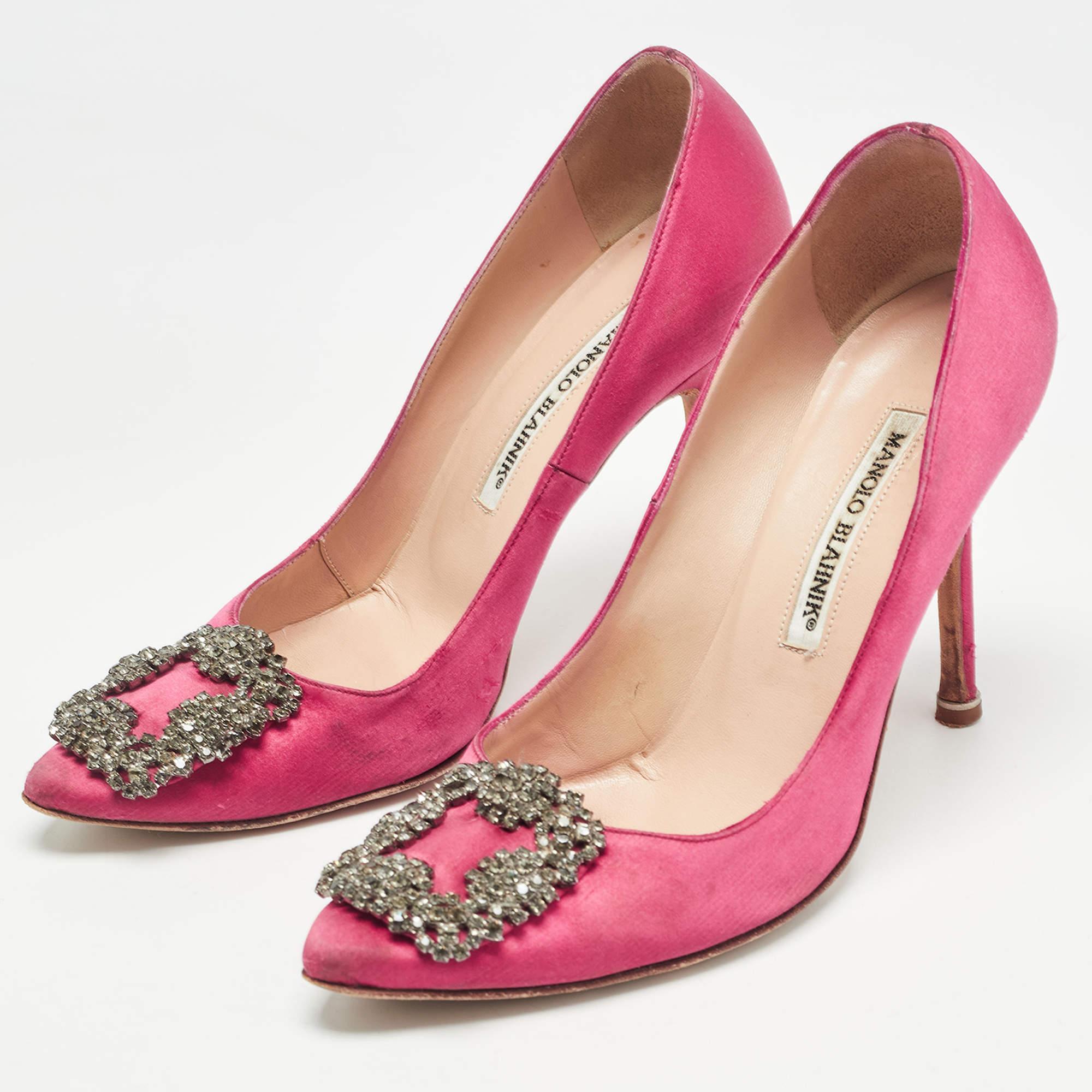 The 10cm heels of this pair of Manolo Blahnik pumps will reflect grace and luxury in every step. Made from satin it is made striking with crystal embellished buckle detailing on the toes and exhibits branded insoles.