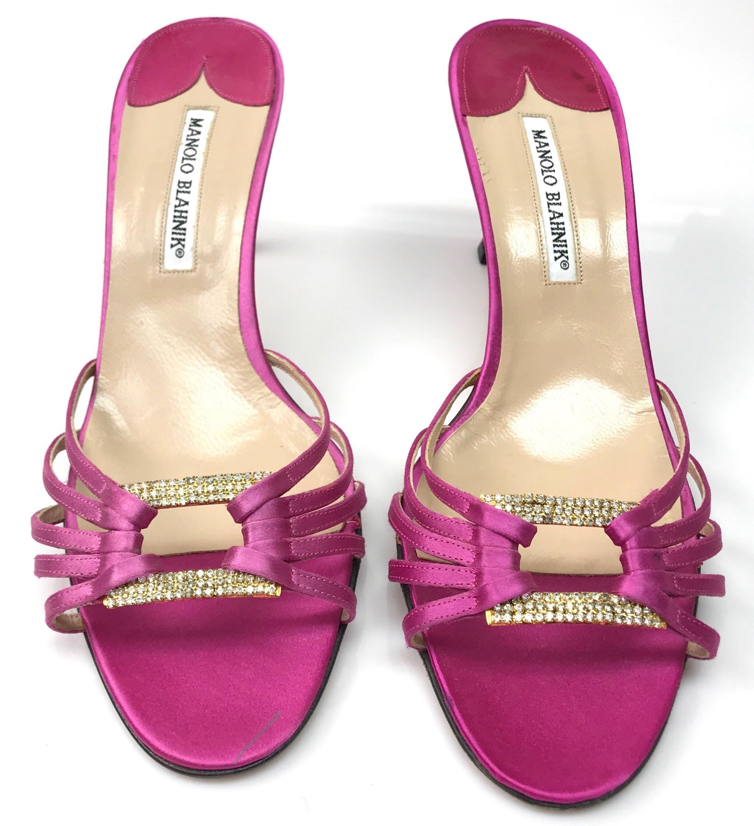 Manolo Blahnik Pink Satin Strappy Heel-40. These elegant Manolo Blahnik are in good condition. They show minor water marks on the bottom of the shoe and a pen mark across the tip of the toe. They are a pink satin short heel with a strappy front.