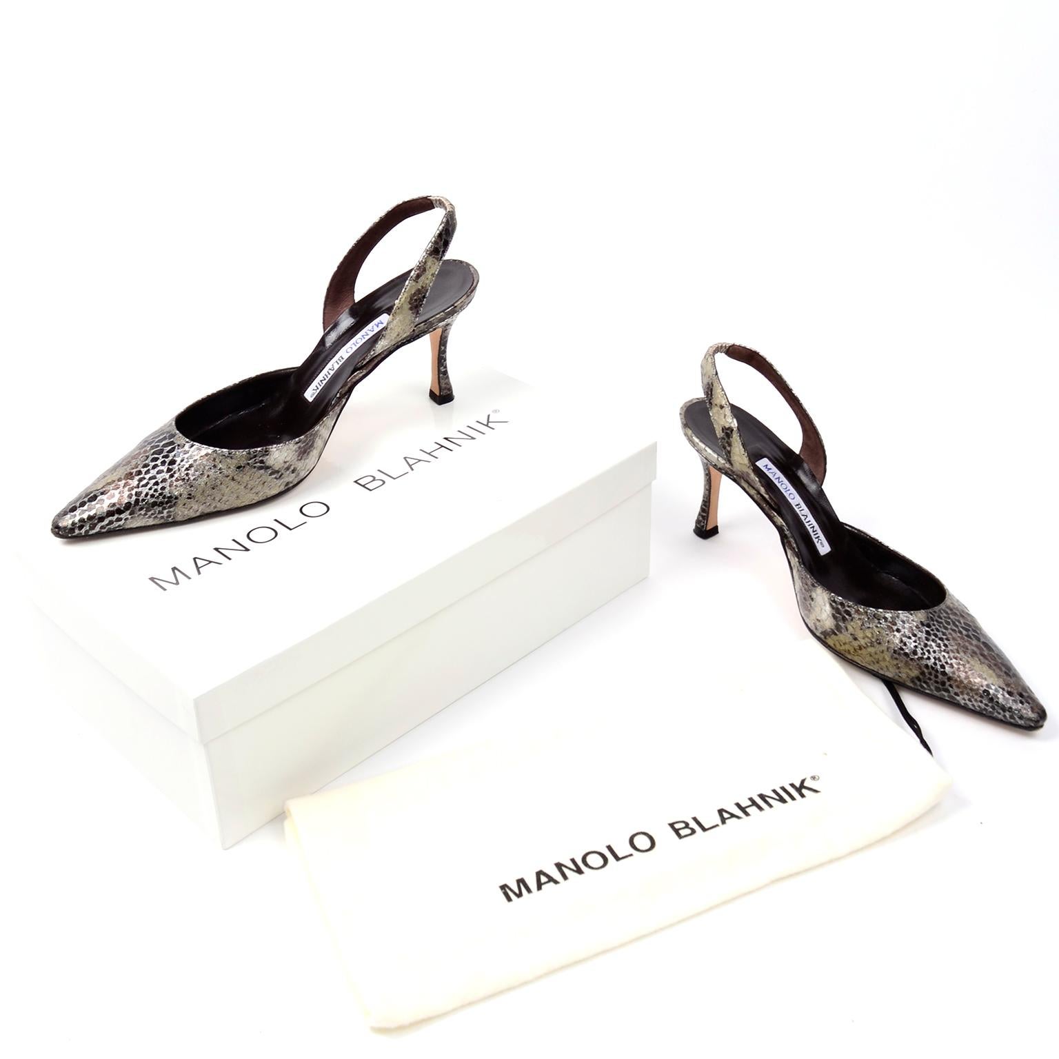 These timeless Manolo Blahnik pointed toe leather slingbacks are in a gorgeous metallic snakeskin pattern with hues of silver and green. The back of the slingback is elastic for easy entry. These beautiful shoes were hand made in Italy and the style