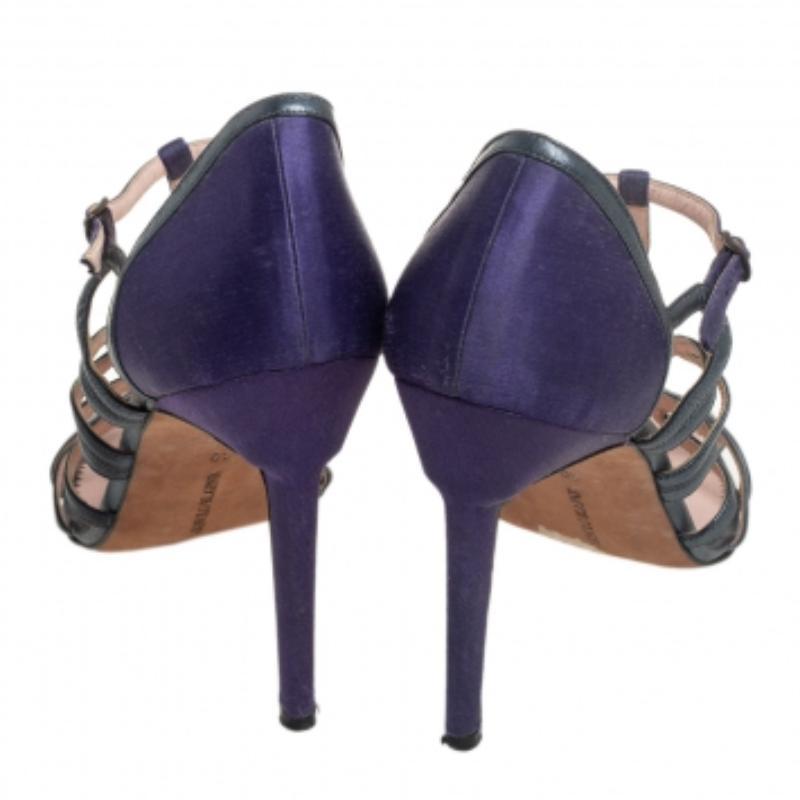 These sandals from Manolo Blahnik are simply fabulous! The purple and grey sandals are crafted from satin and leather and feature an open-toe silhouette. They flaunt a cage design and come equipped with buckled ankle straps, comfortable leather