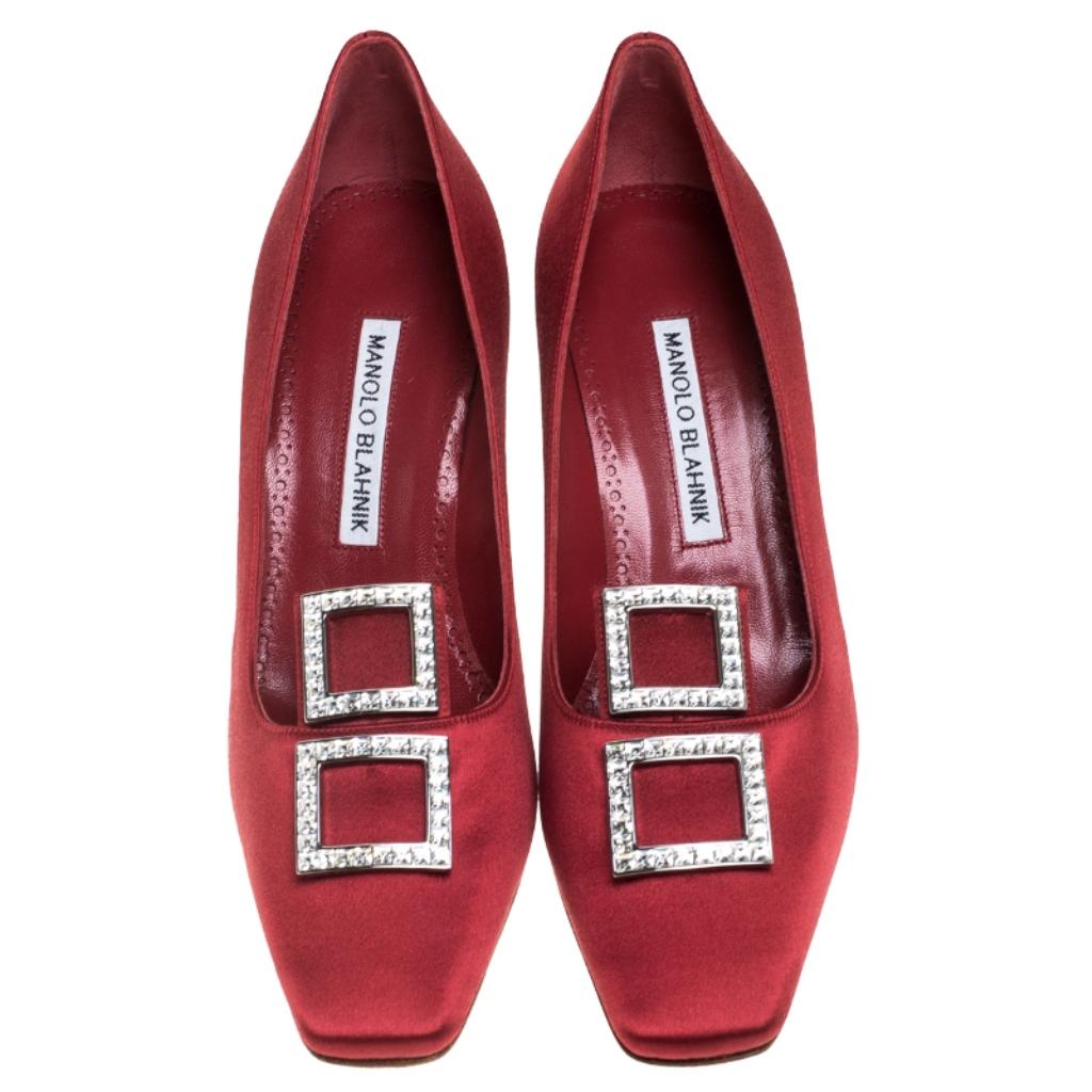 Step out in sophistication and style when you don this pair of Manolo Blahnik pumps. Made from fine satin, these red pumps will make an elegant addition to your wardrobe. They bring crystal detailing on the uppers and a set of 7.5 cm