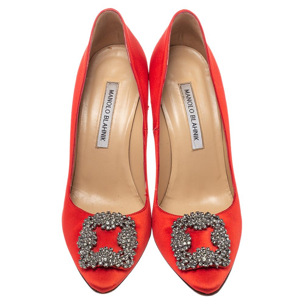 These iconic pumps are by Manolo Blahnik. Styled in red satin with dazzling embellishments on the toes and leather insoles to provide comfort, these pumps will never fail to lift your outfits. Complete with 10 cm heels, you can wear them with