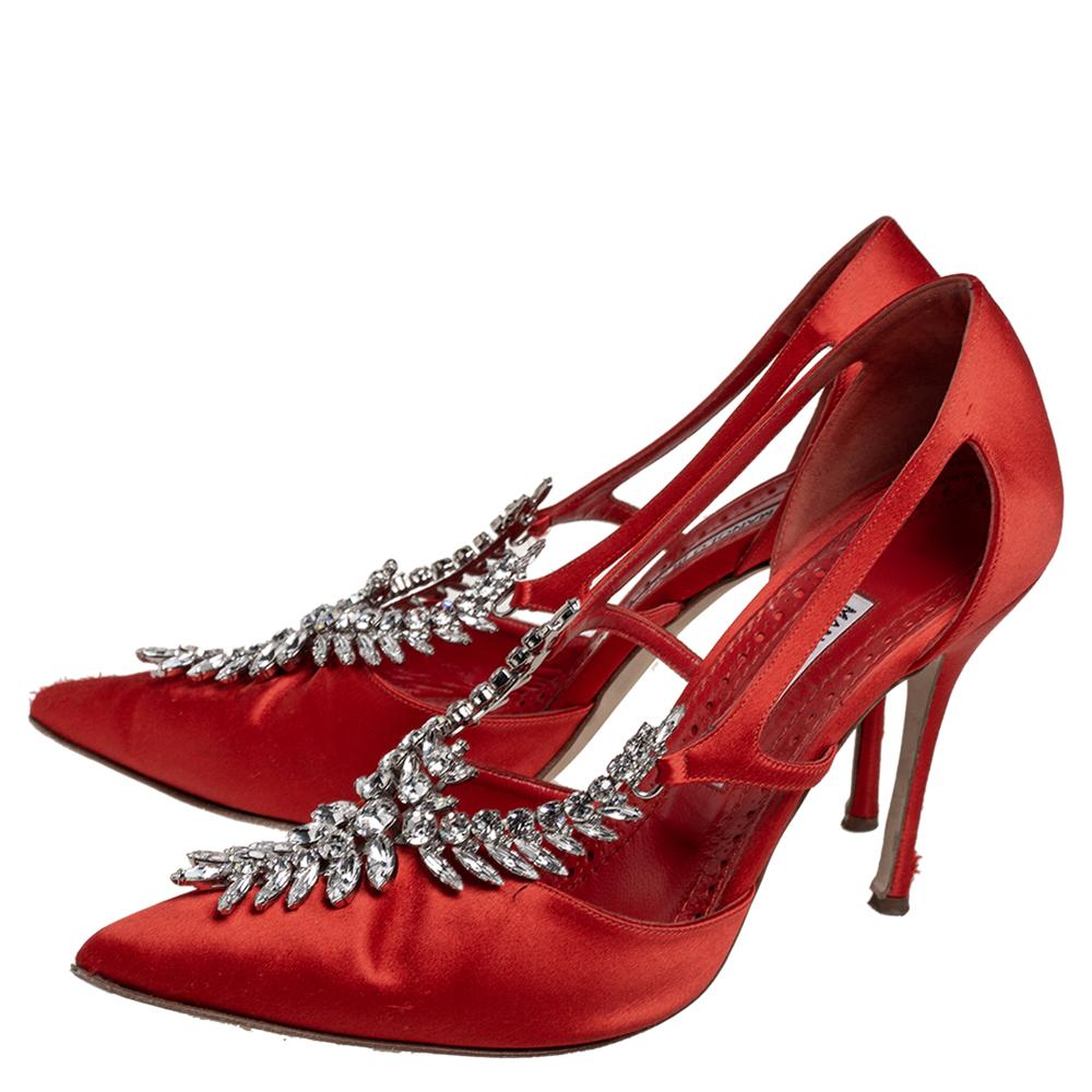A worthy choice for those who love elegant footwear, Manolo Blahnik's Lala pumps meet the expectations of a luxurious shoe. Formed using red-hued satin, the high heel pump is presented with cut-outs for an exposed look and gleaming crystals for a