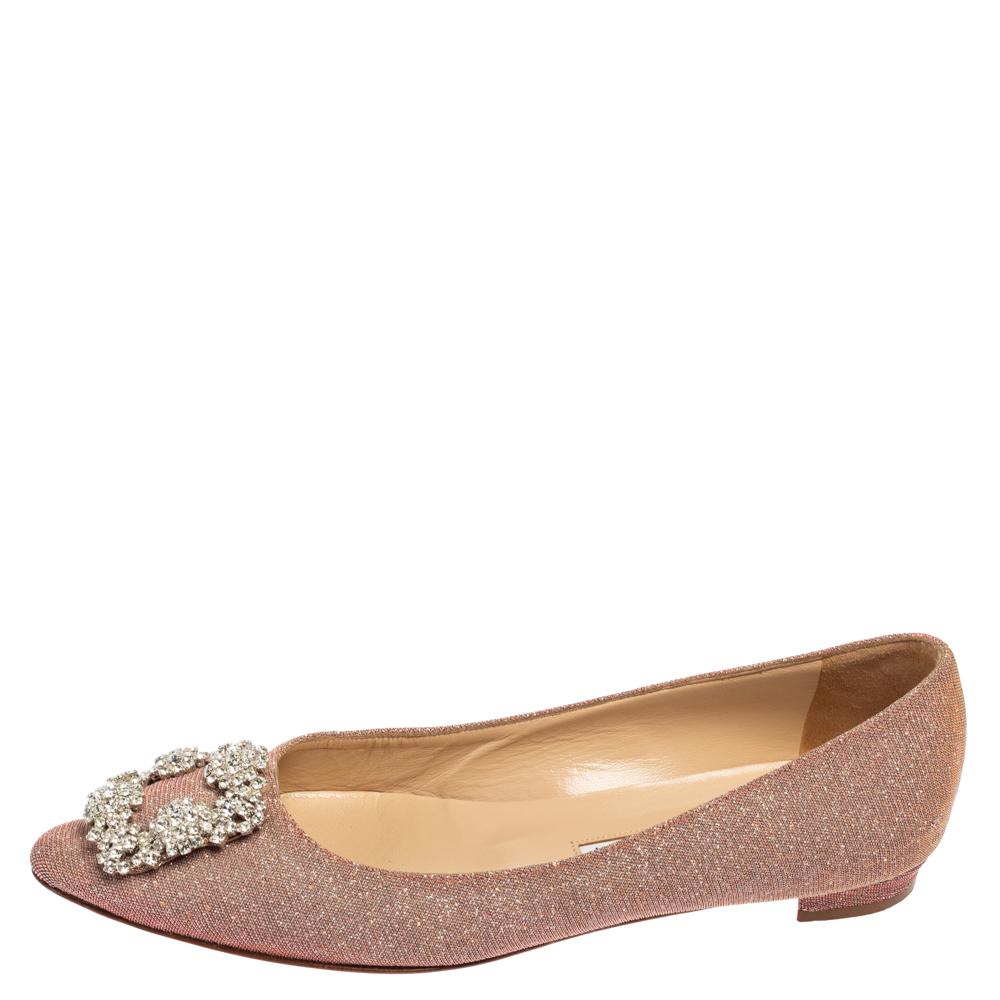 Manolo Blahnik is well-known for his graceful designs, and his label is synonymous with opulence, femininity, and elegance. These Hangisi ballet flats are crafted from shimmery fabric in a salmon pink shade into a pointed toe silhouette augmented by