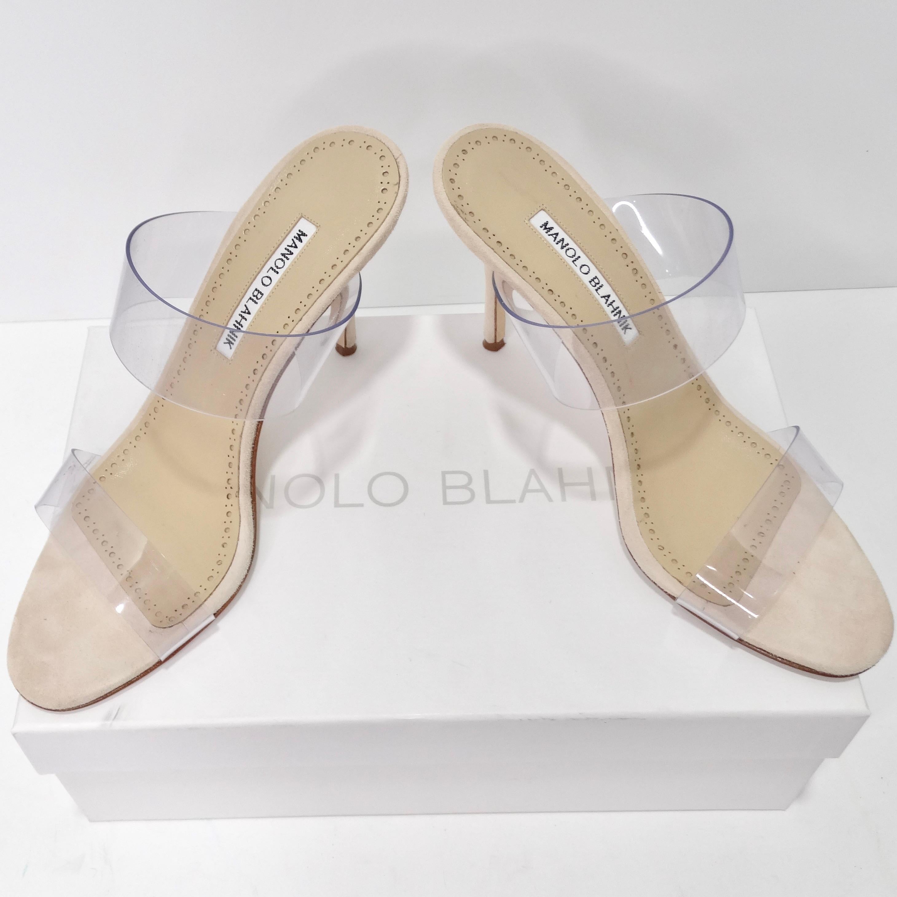 Introducing the Manolo Blahnik Scolto Clear ECO PVC Open Toe Mules, the ultimate versatile shoe choice for those who want to flaunt their pedicure and stay on-trend. These high-heeled mules embody contemporary elegance with their trendy mule style.