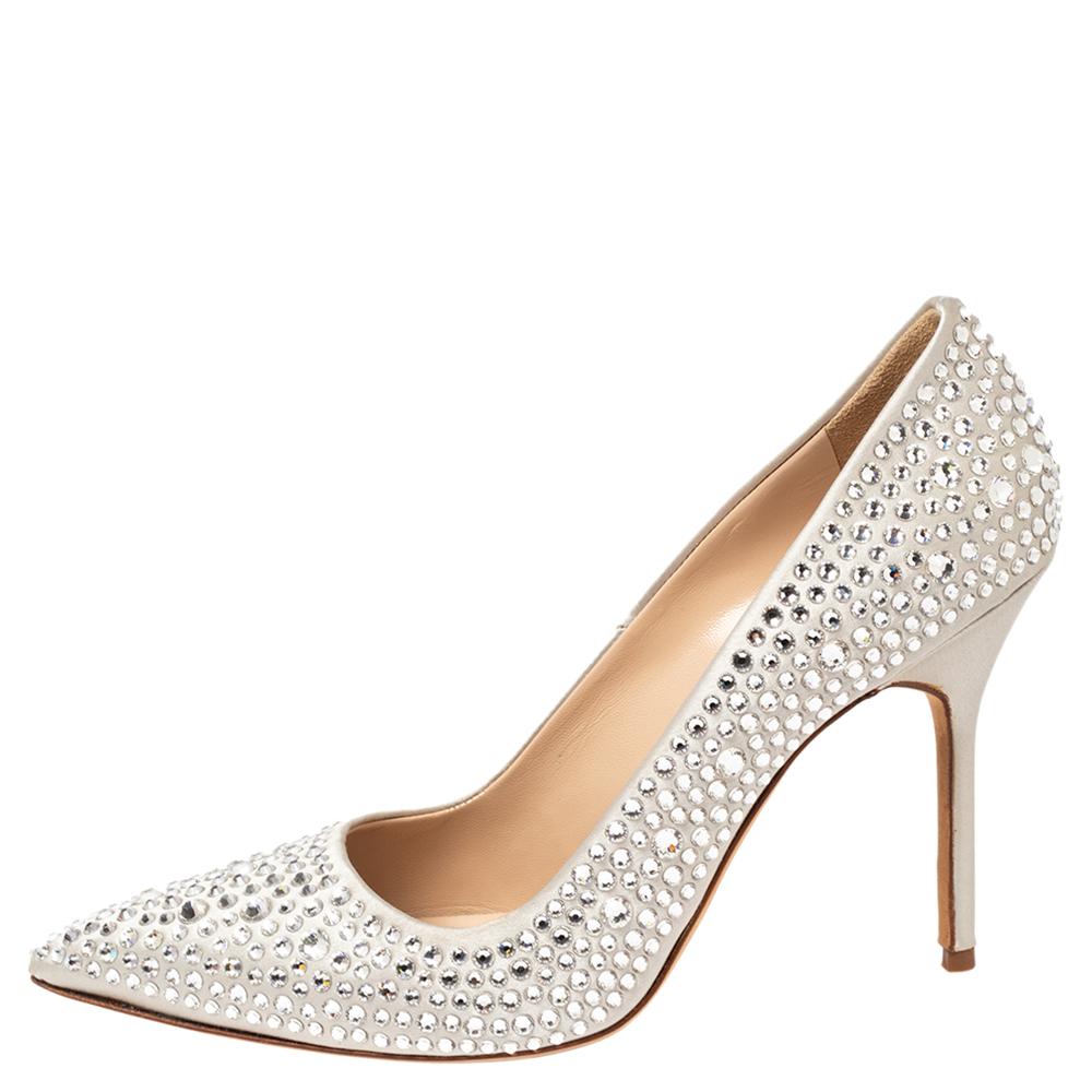 Chase your woes away by wearing this pair of magnificent pumps, that have been created from crystal-embellished satin. They come in silver with pointed toes and 10.5 cm heels. You're sure to feel your best while walking about in this pair of classy