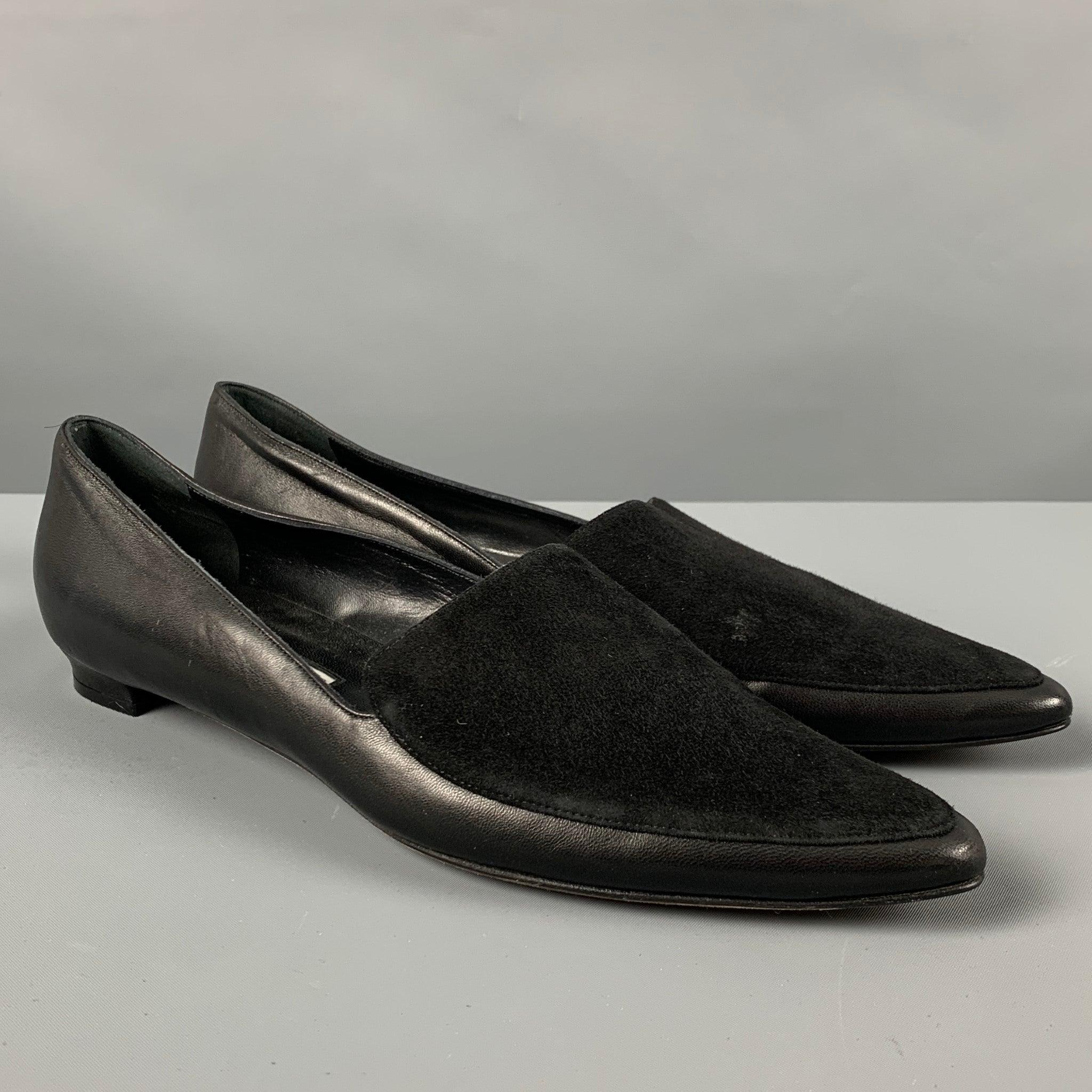 MANOLO BLAHNIK flats
in a black leather fabric with suede upper detail, featuring a pointed toe. Handmade in Italy.Very Good Pre-Owned Condition. Minor signs of wear. 

Marked:   40.5Outsole:11 inches  x 3.5 inches 
  
  
 
Reference: