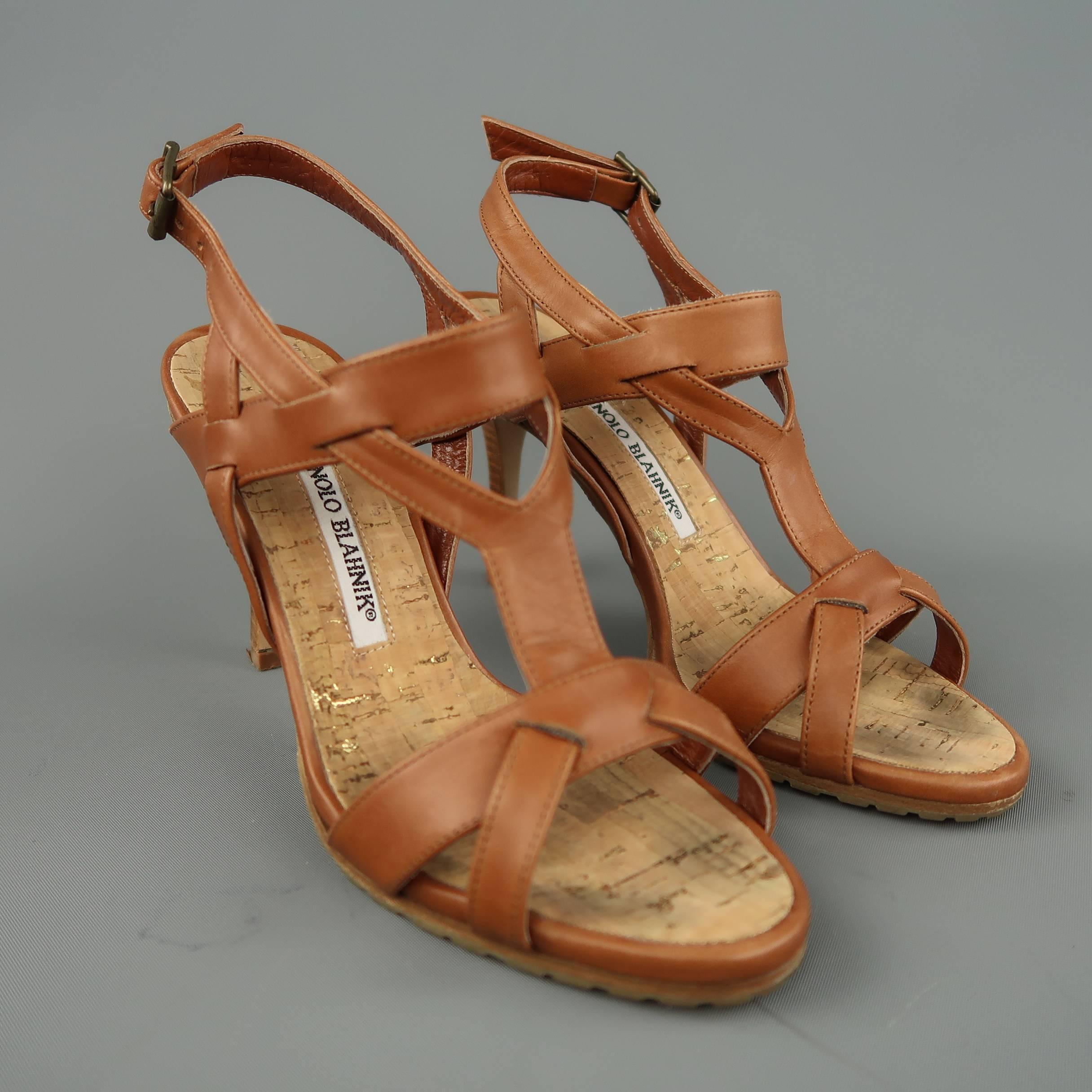 MANOLO BLAHNIK sandals come in tan leather with a strappy Y harness, cork sole, and stacked stiletto heel. Made in Italy.
 
Good Pre-Owned Condition.
Marked: IT 35.5
 
Measurements:
 
Heel: 3.75 in.

