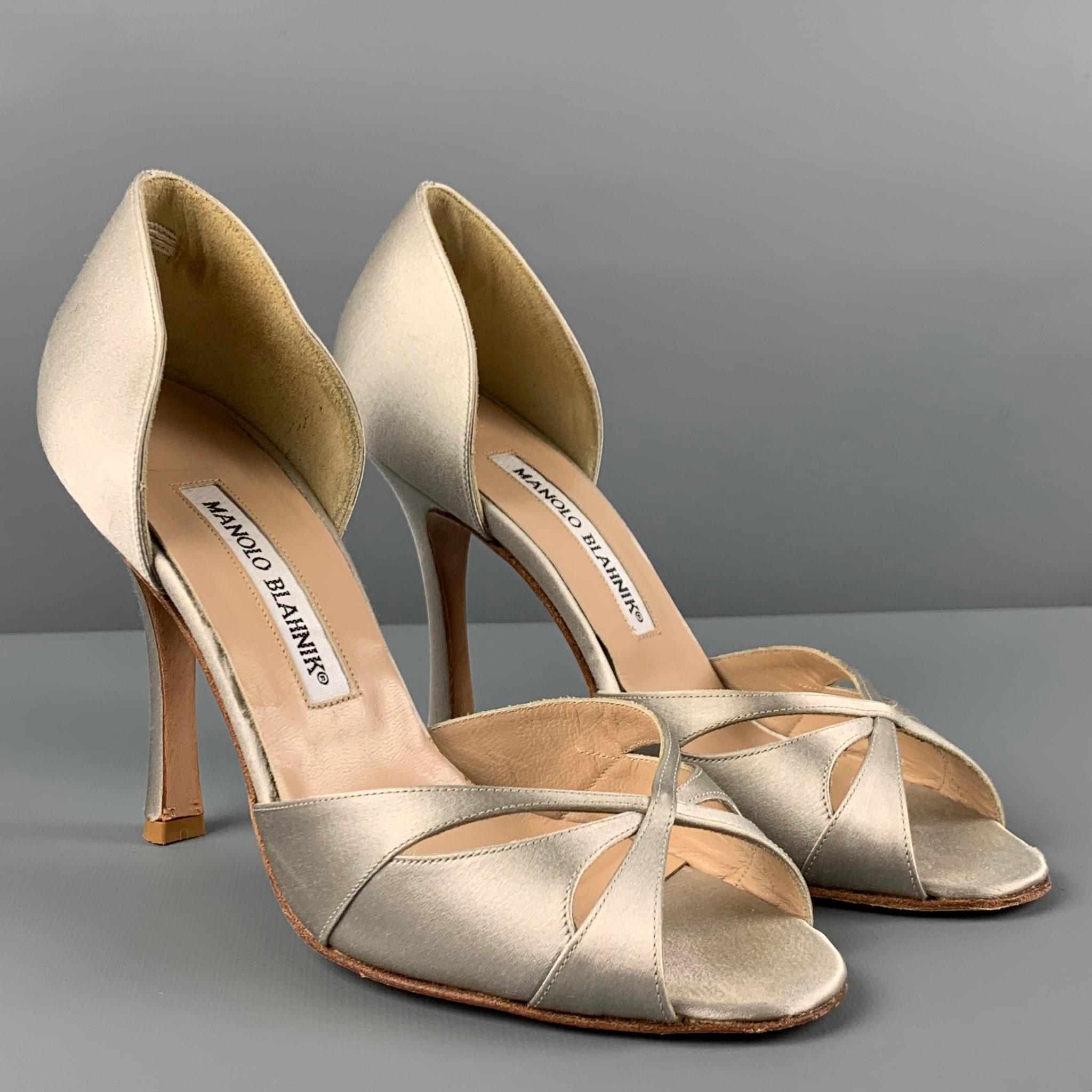 MANOLO BLAHNIK pumps comes in a gray silk featuring a d'orsay style, open toe, and a stiletto heel. Made in Italy. 

Very Good Pre-Owned Condition.
Marked: 36.5

Measurements:

Heel: 4 in. 