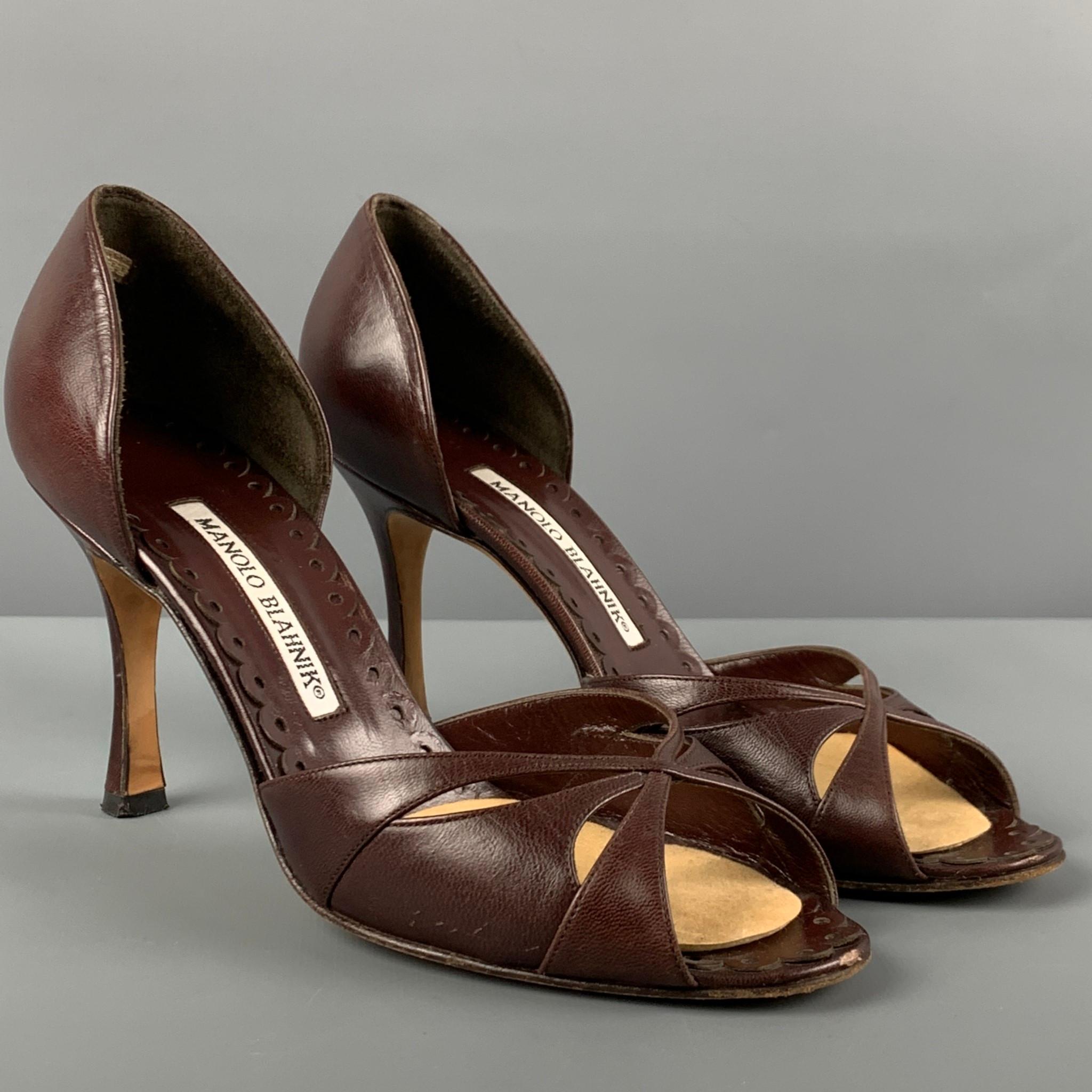 MANOLO BLAHNIK pumps comes in a brown leather featuring a d'orsay style, open toe, and a stiletto heel. Made in Italy. 

Very Good Pre-Owned Condition.
Marked: 37

Measurements:

Heel: 3.5 in. 
