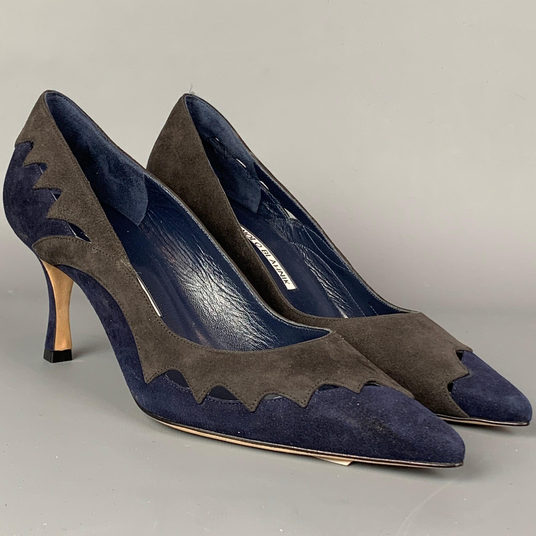 MANOLO BLAHNIK pumps comes in a grey & navy suede with cut out details featuring a pointed toe and a stacked heel. Comes with dust bag. Handmade in Italy.  Retail $645

Very Good Pre-Owned Condition. Light marks at side.
Marked: IT