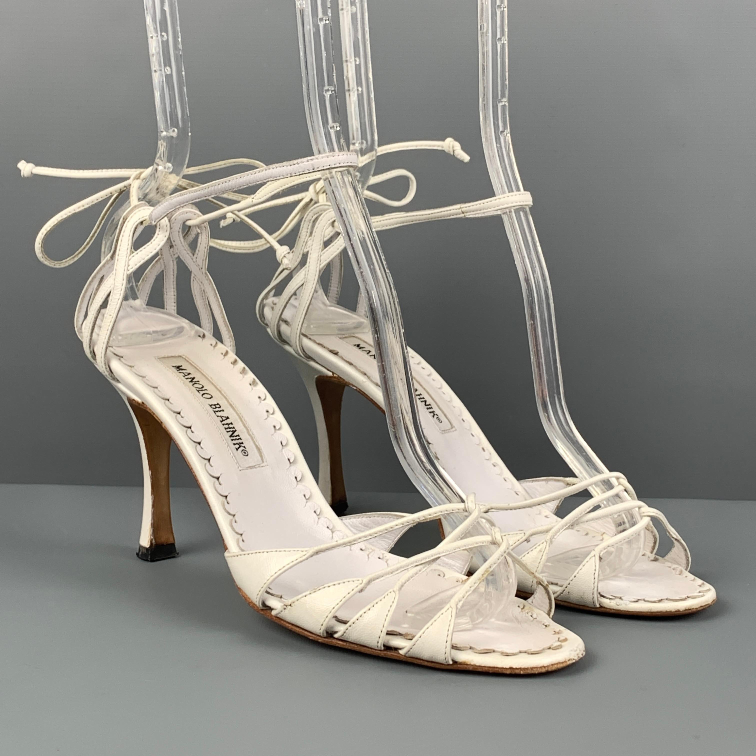 MANOLO BLAHNIK sandals comes in a white leather featuring a open toe, ankle strap, and a stiletto heel. 

Good Pre-Owned Condition. Minor wear. As-Is.
Marked: 37

Measurements:

Heel: 3.5 in. 