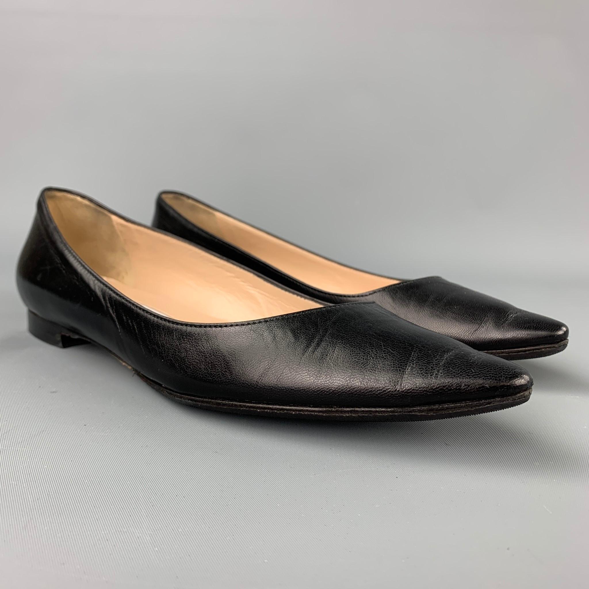 MANOLO BLAHNIK flats comes in a black leather featuring a pointed toe and a wooden heel. 

Very Good Pre-Owned Condition.
Marked: 38
Original Retail Price: $645.00

Outsole: 10.5 in. x 3 in. 