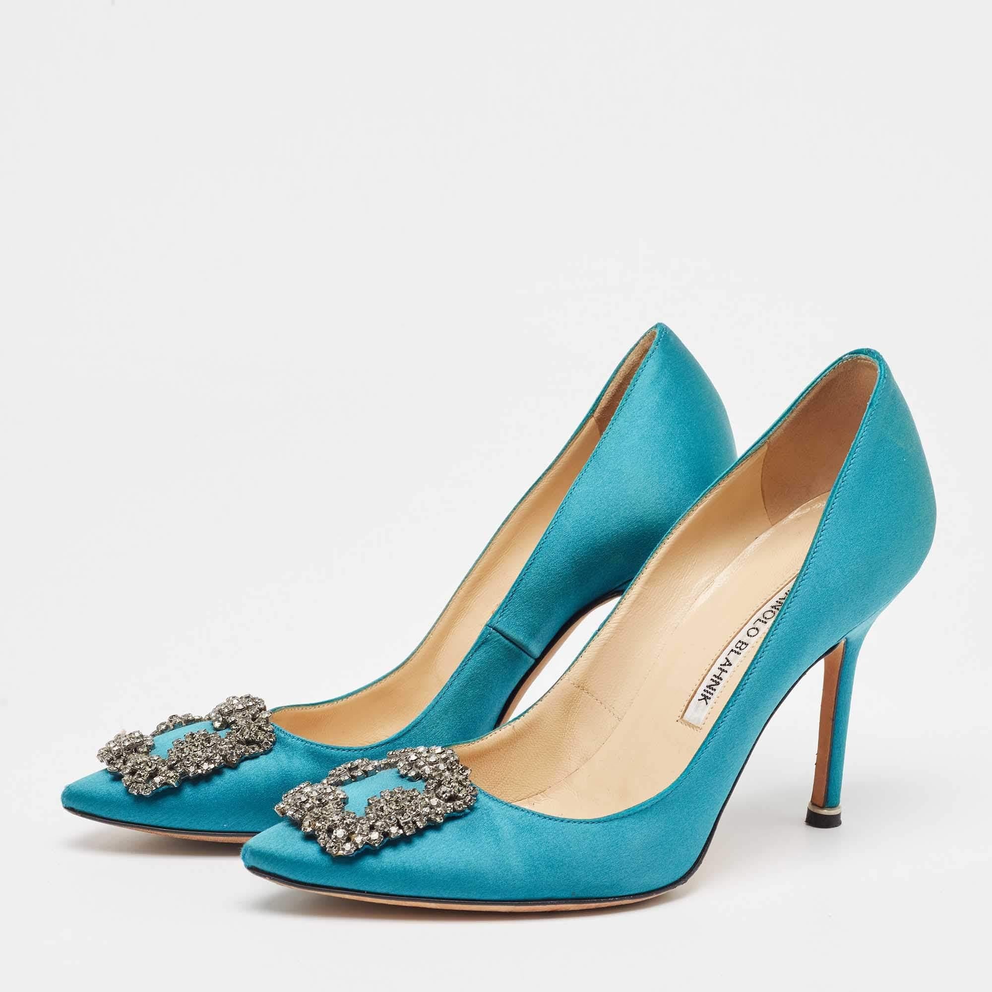 The 10cm heels of this pair of Manolo Blahnik mules will reflect grace and luxury in every step. Made from satin it is made striking with crystal embellished buckle detailing on the toes and exhibits branded insoles.
