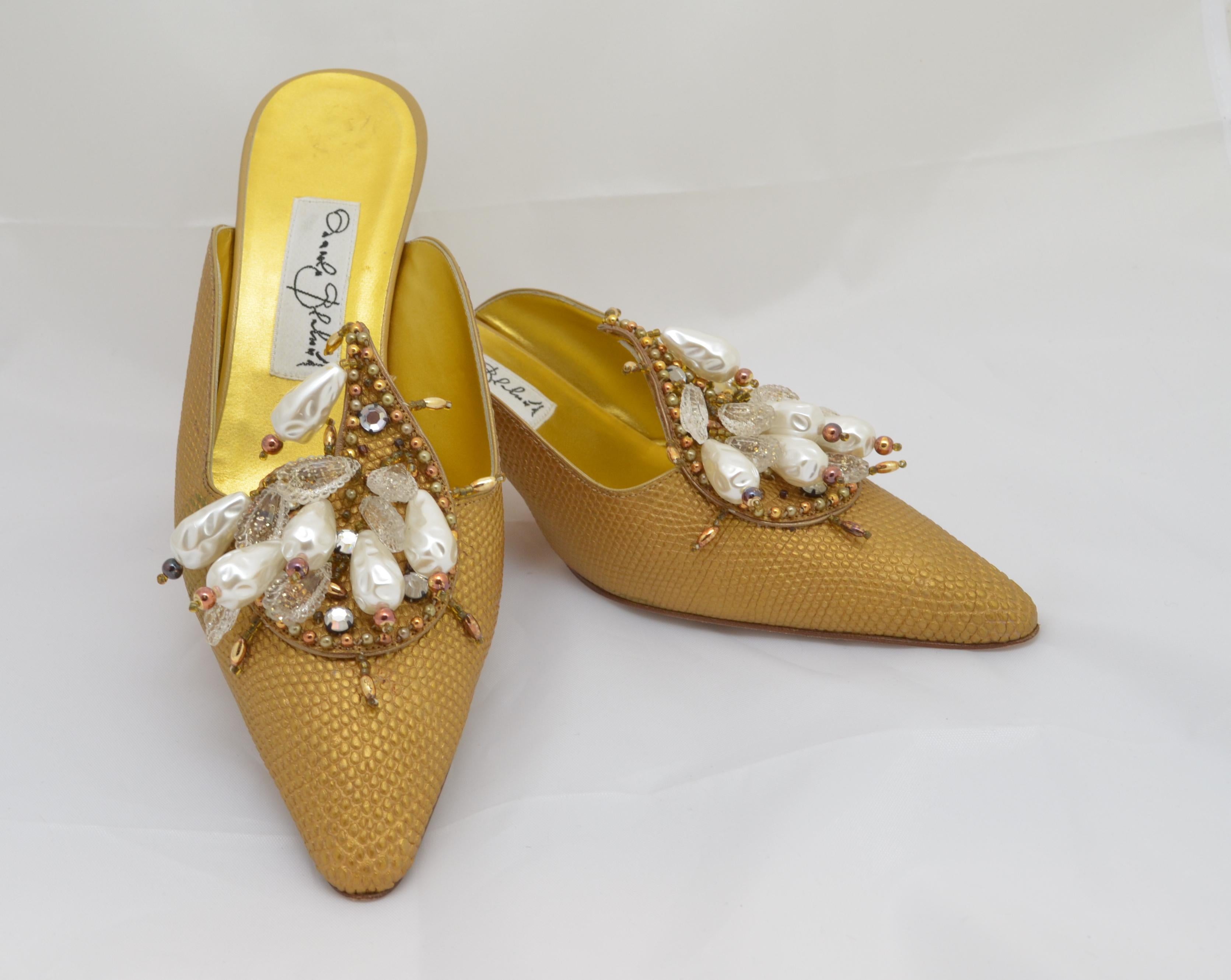 The shoes of Manolo Blahnik are internationally renowned for their beauty and elegance. These mules, with their low, curved heel and lavish ornamentation are an example of Blahnik's love of historic design, in particular the styles of the 18th