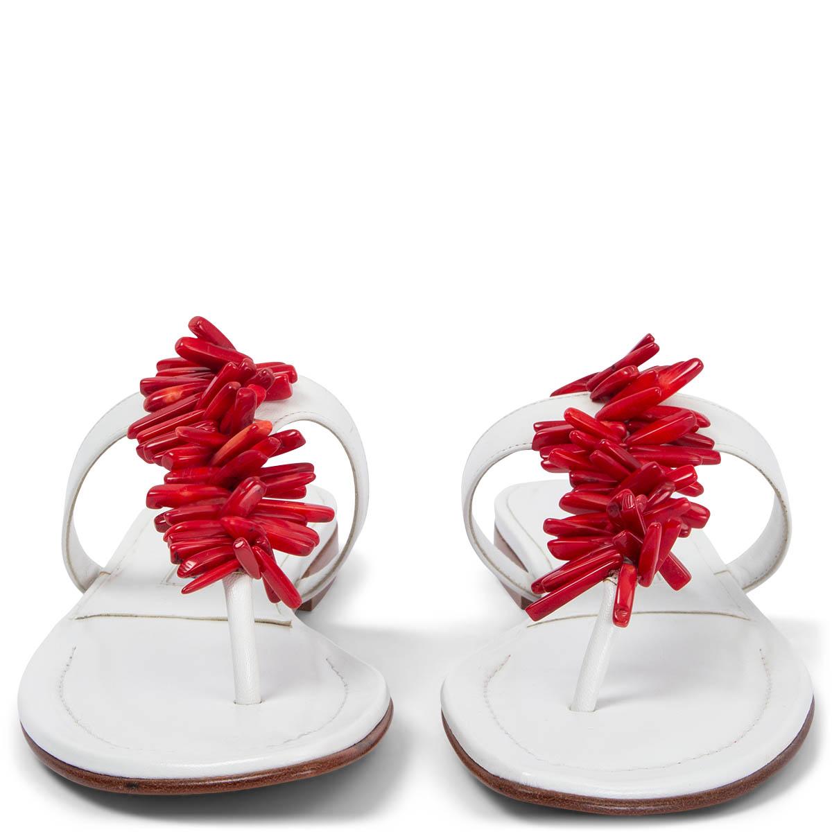 100% authentic Manolo Blahnik thong sandals in white calfskin embellished with red coral beads. Brand new. 

Measurements
Imprinted Size	36.5
Shoe Size	36
Inside Sole	23cm (9in)
Width	7cm (2.7in)
Heel	2cm (0.8in)

All our listings include only the