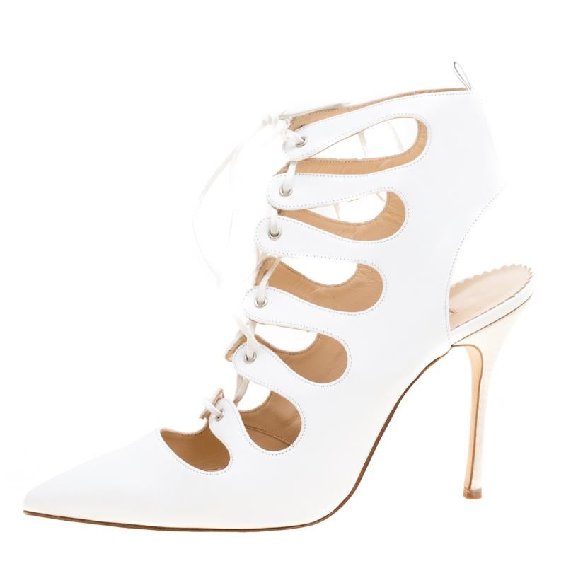 With a pair of booties as these Manolo Blahnik's, you are sure to win admiring glances! These white booties are crafted from leather and feature pointed toes. They flaunt a cutout design with lace-ups that run from the middle up to the top.