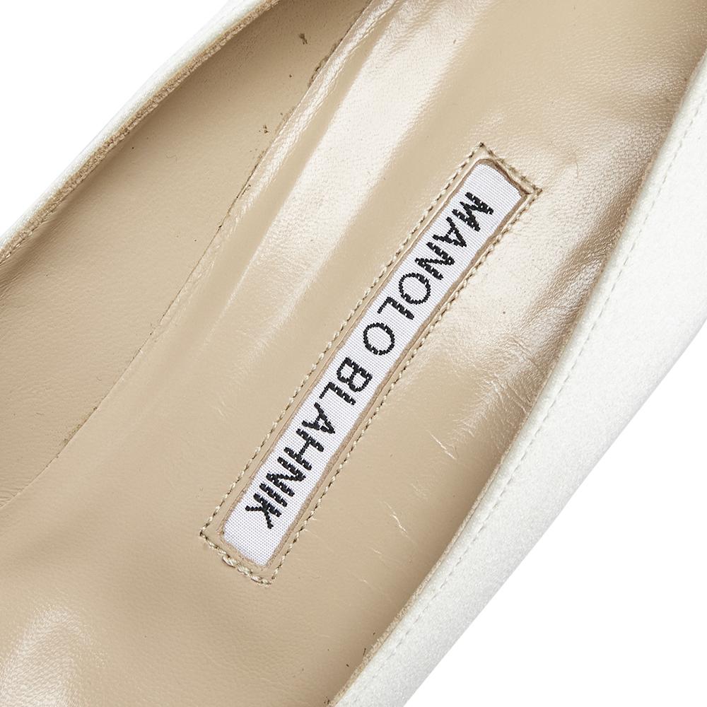 Manolo Blahnik is well-known for his graceful designs, and his label is synonymous with opulence, femininity, and elegance. These Hangisi pumps are crafted from satin into a pointed toe silhouette augmented by the embellishments perched on the