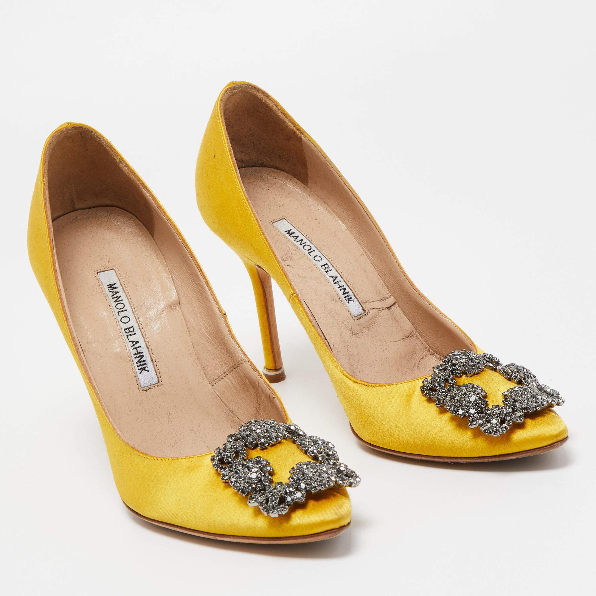 The 10cm heels of this pair of Manolo Blahnik pumps will reflect grace and luxury in every step. Made from satin, it is made striking with crystal-embellished buckle detailing on the toes and exhibits branded insoles.

