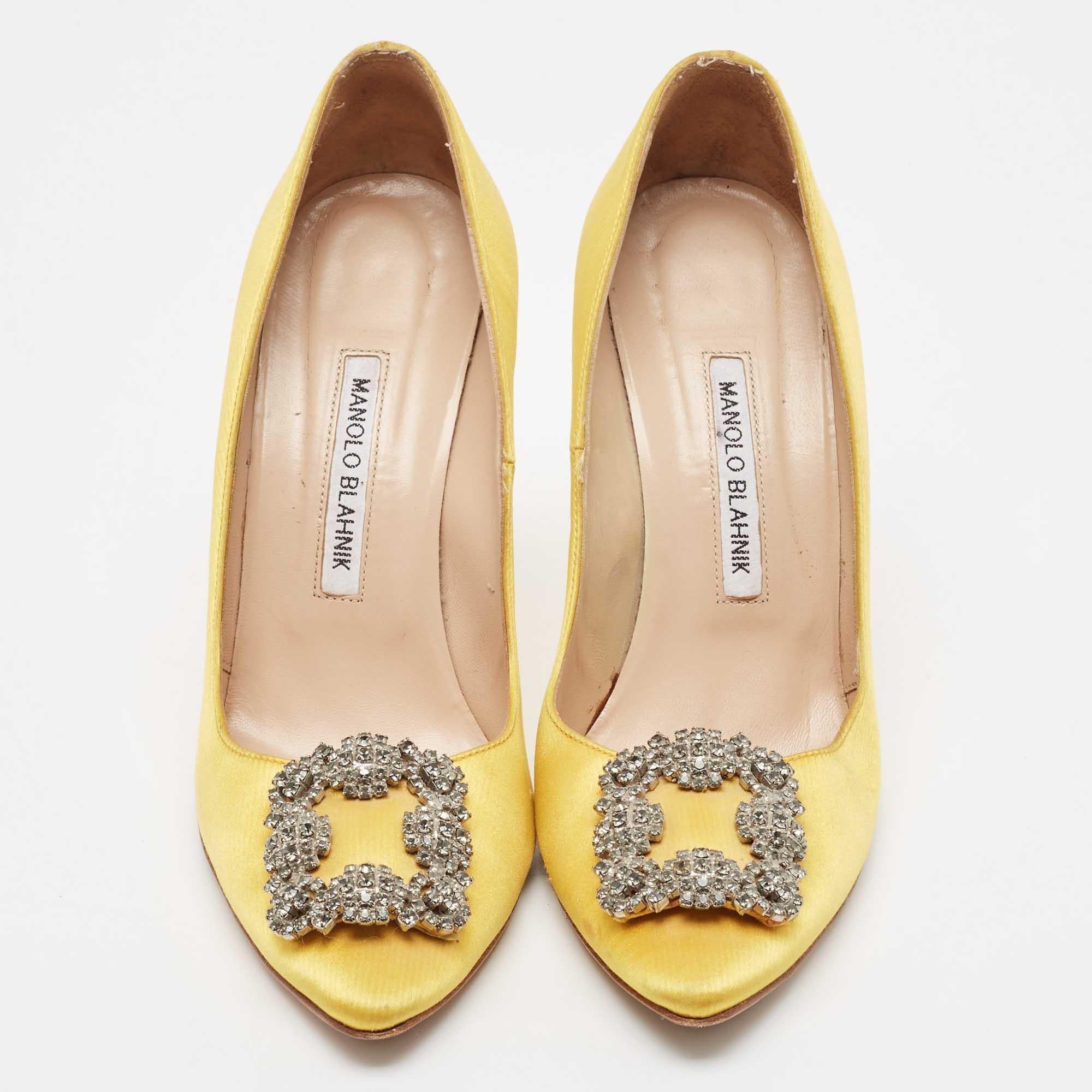 The 11.5cm heels of this pair of Manolo Blahnik pumps will reflect grace and luxury in every step. Made from satin, it is made striking with a crystal-embellished buckle detailing on the toes and exhibits branded insoles.


