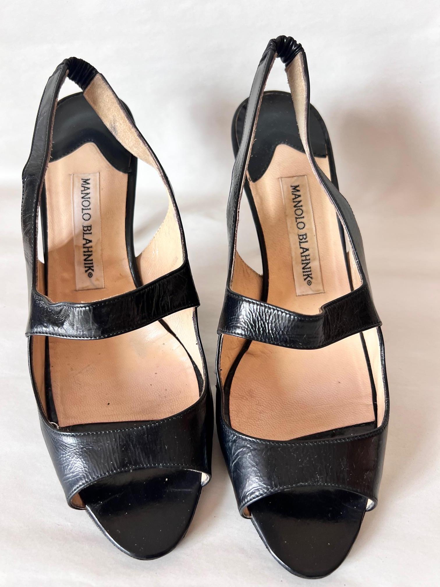 Manolo Blanick Black Satin Leather Cocktail Open Back Shoes
Made In: Italy
Color: Black
Material: Satin Leather 
Marked Size: 38,5 Europe
Heel Height: 9 cm/ 3,54 inches

His name has become synonymous with women’s luxury shoes, yet Manolo Blahnik is