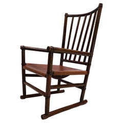 Manou rattan armchair with leather seat, 1960