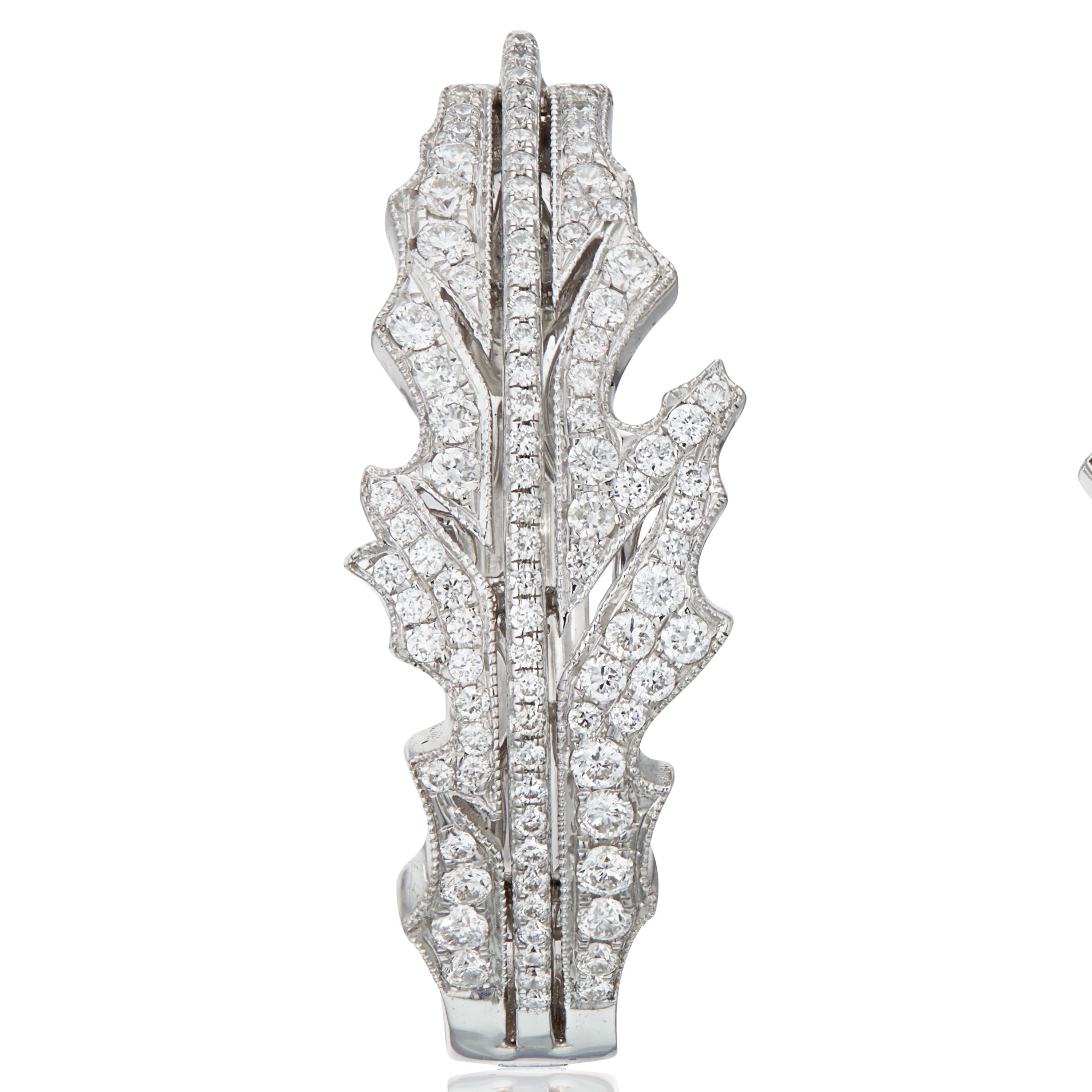 The total diamond weight in the pair of earrings is 0.81 carats. 
Gross weight is 12.830 grams
Gold weight is 12.680 grams

Matching ring available.

This elegant pair of 18k white-gold hoops , in a foliate pattern inspired by a vintage brooch, is